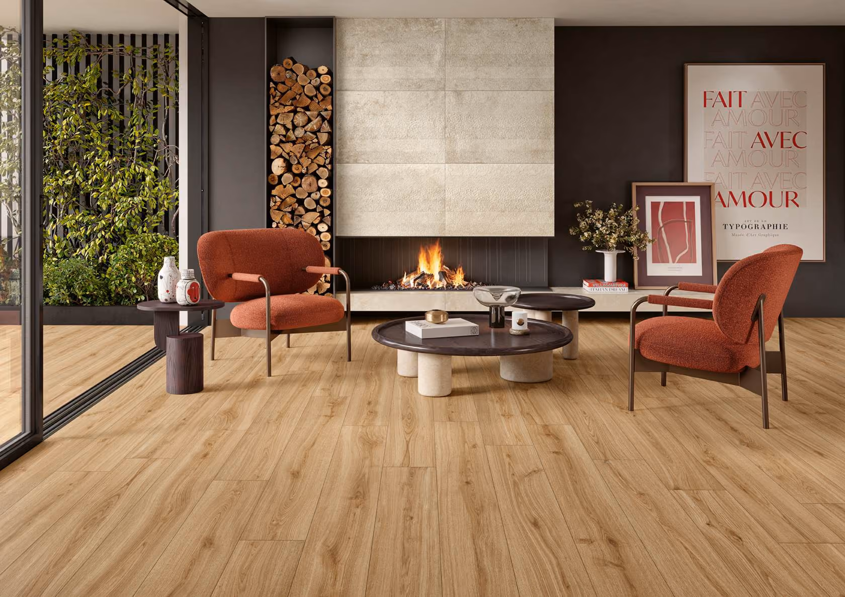 Modern living room with wood flooring, two rust chairs, black tables, fireplace, and wall art.