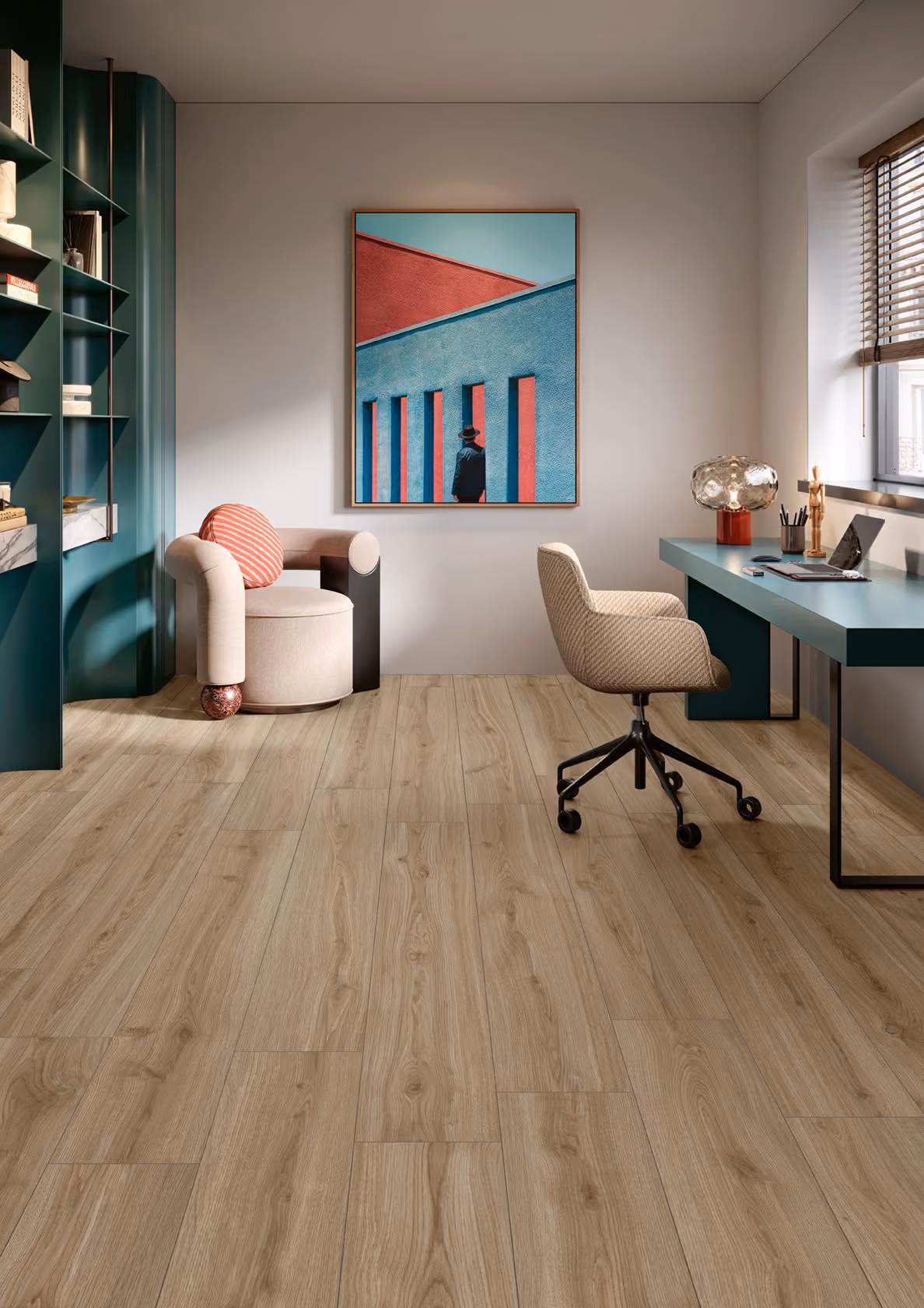 Modern office with wood floor, teal desk, beige swivel chair, and beige round armchair with pillow.