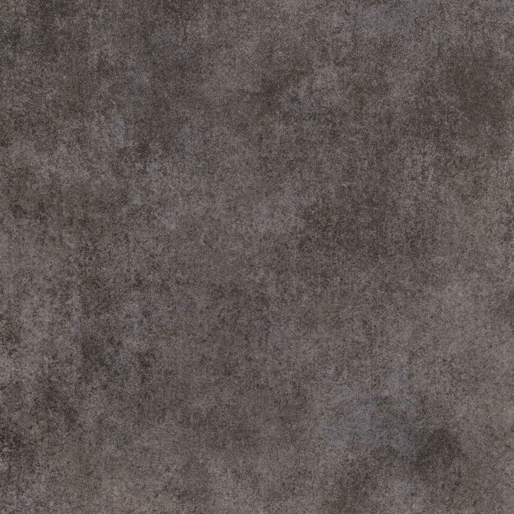 Close-up of a textured dark gray stone or concrete surface with uneven color patterns.