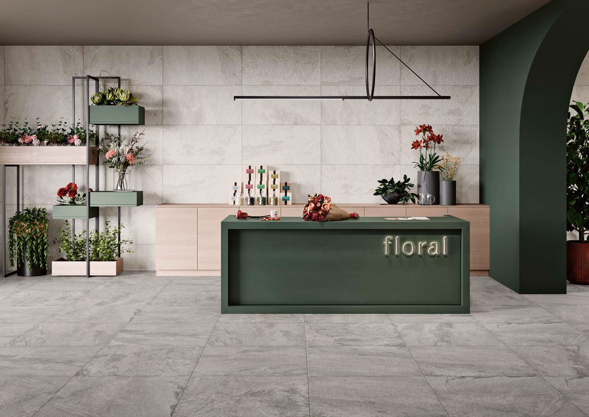 Modern flower shop interior with green counter labeled floral, plants, flowers, and wall shelves.