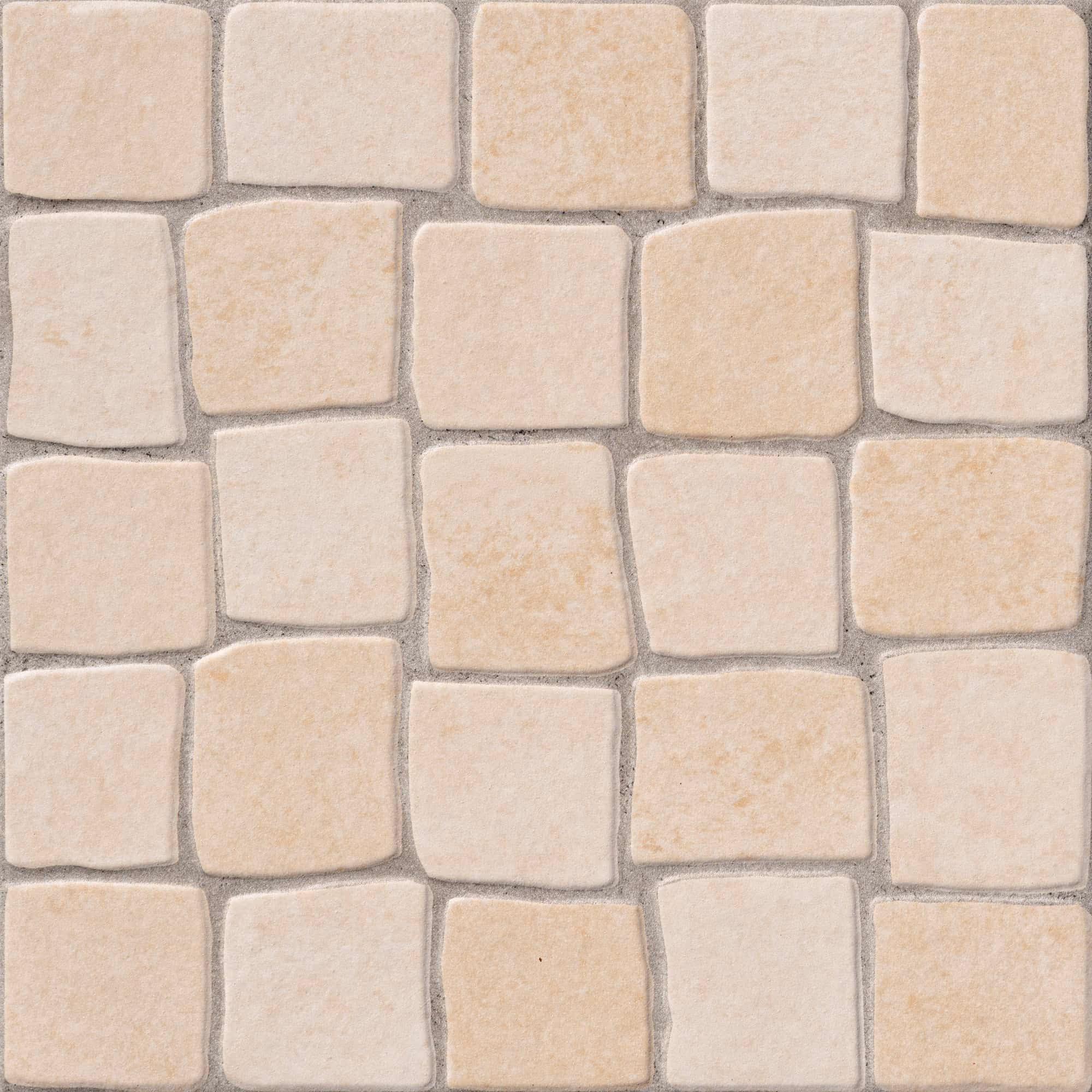 Square beige stone tiles arranged in a grid with gray grout in between.
