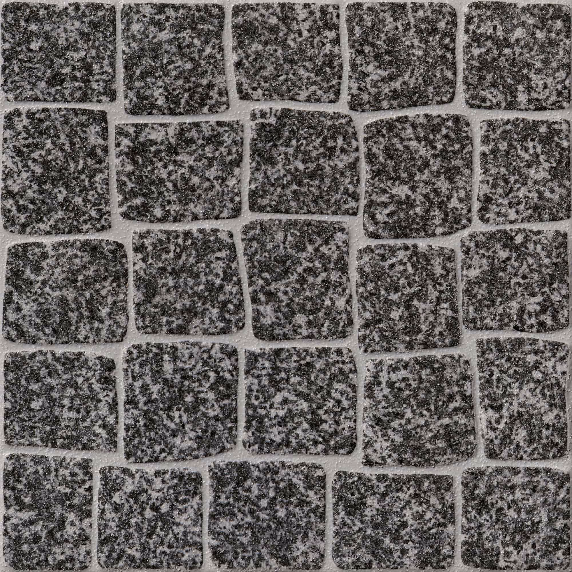 Pattern of irregular dark gray granite cobblestones with light gray grout between them.