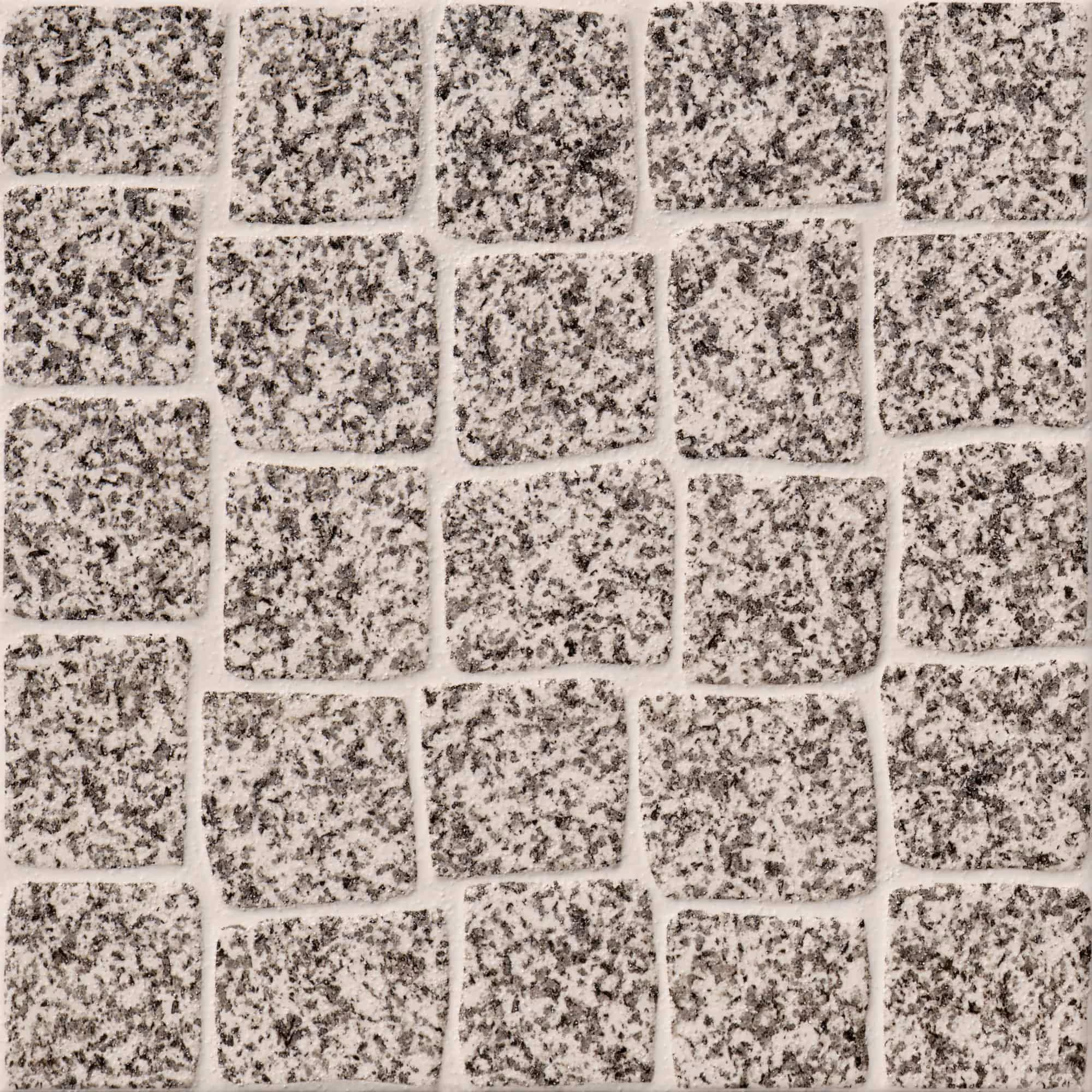 Close-up of textured stone tiles arranged in a grid pattern with light grout.