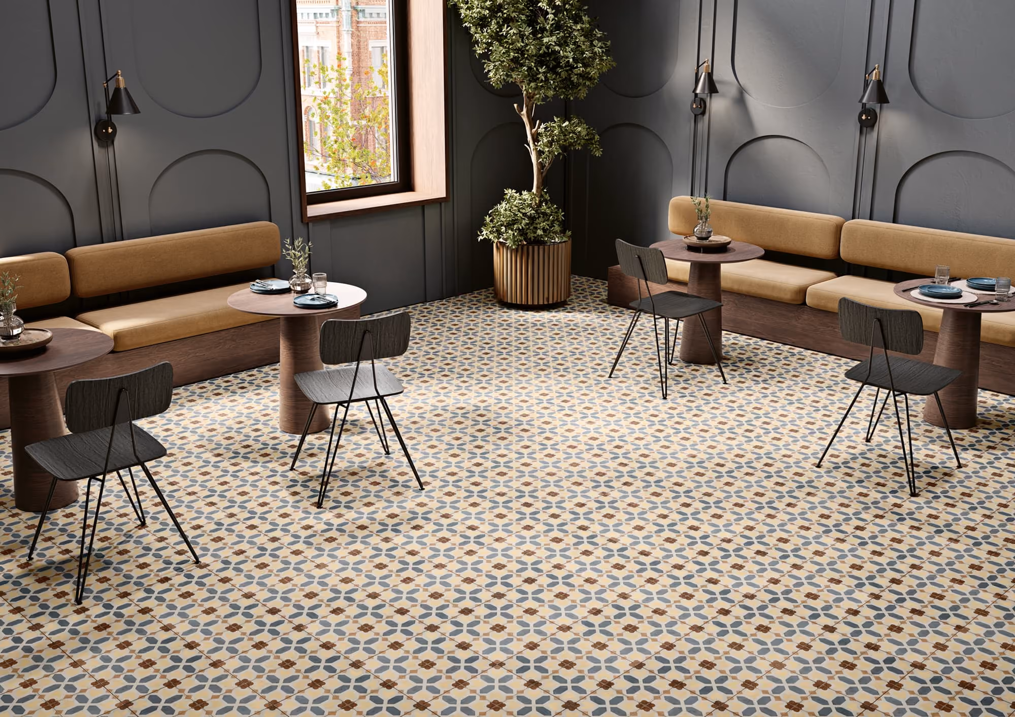 Cozy cafe with patterned tile floor, wooden tables, black chairs, and mustard-colored bench seating.
