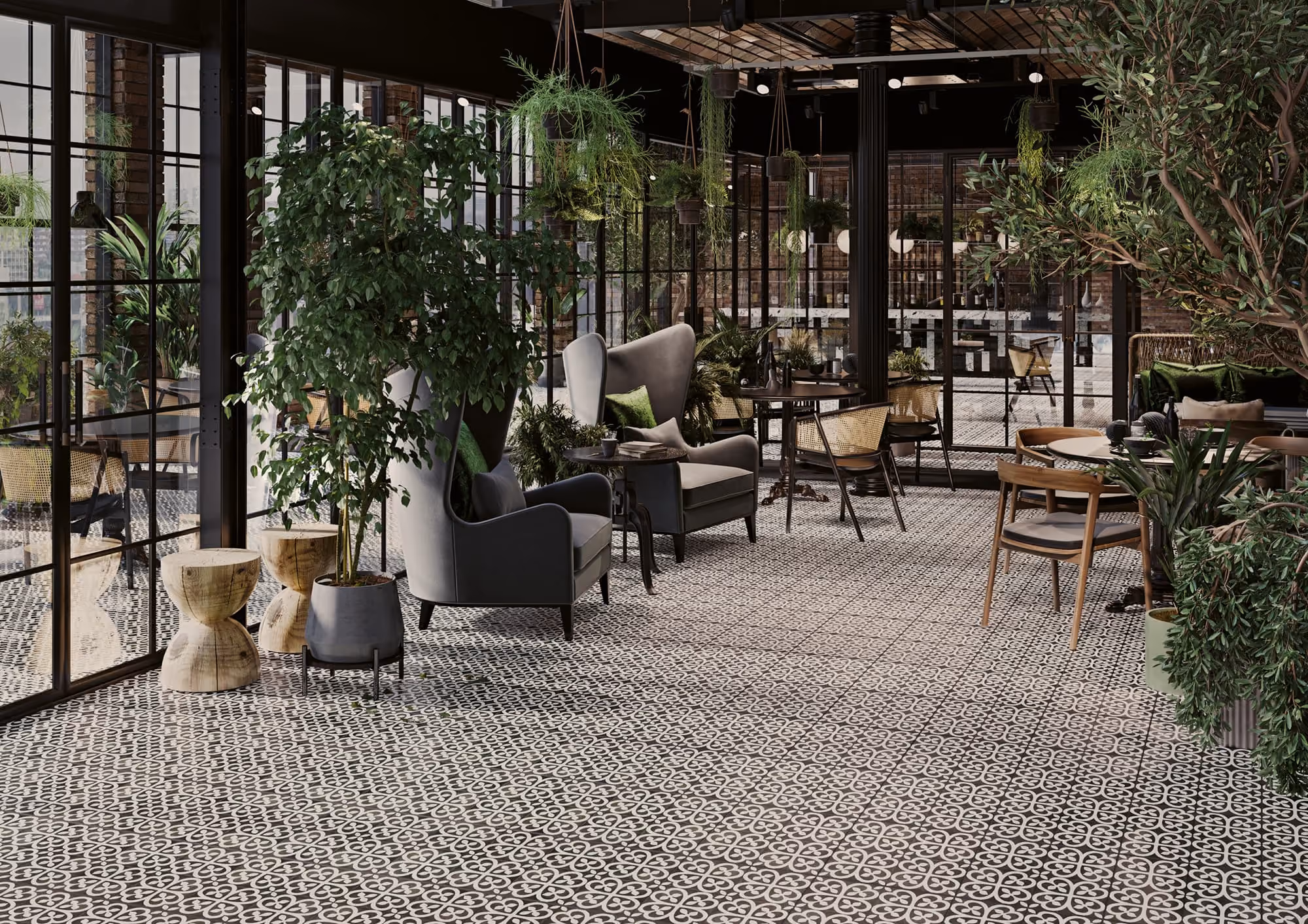 Cozy indoor café seating with patterned tile floor, green plants, gray armchairs, and wooden tables.