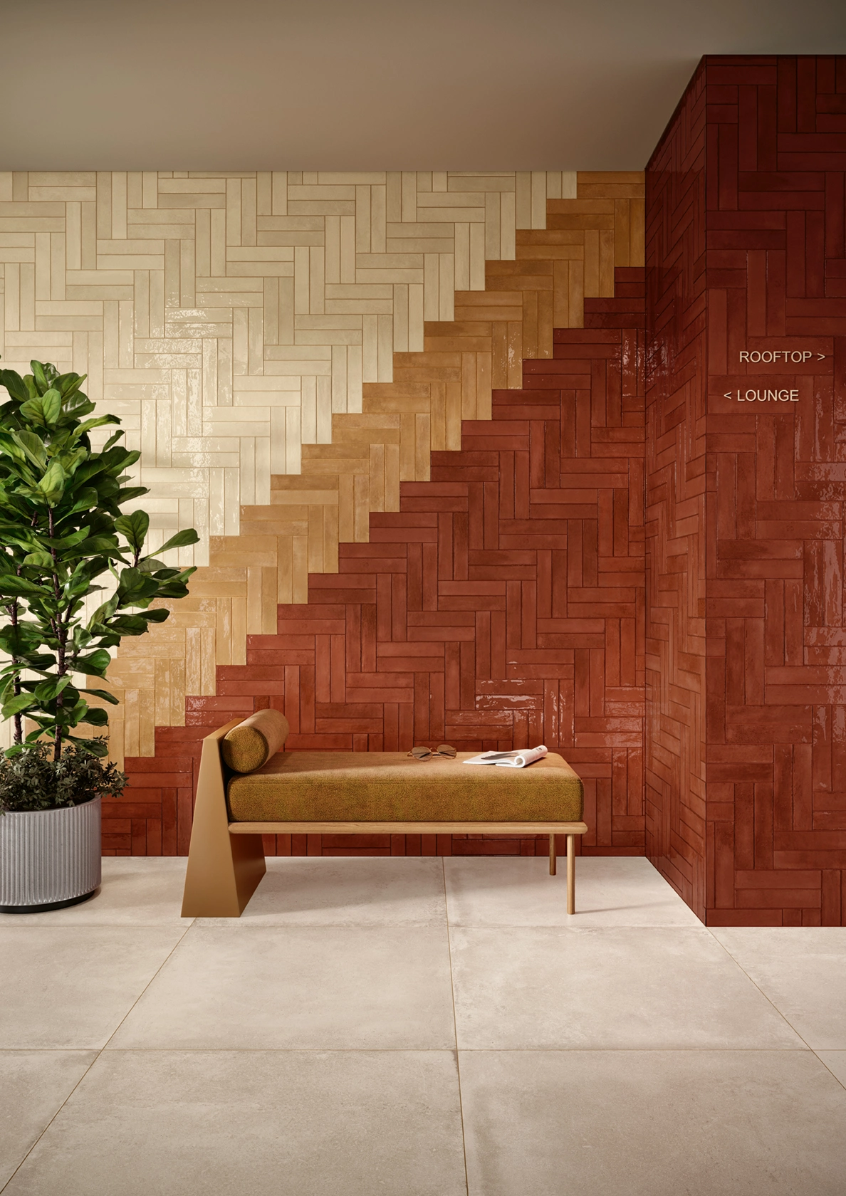 Modern bench with cushion and plant by a wall with red, orange, and beige herringbone tiles.