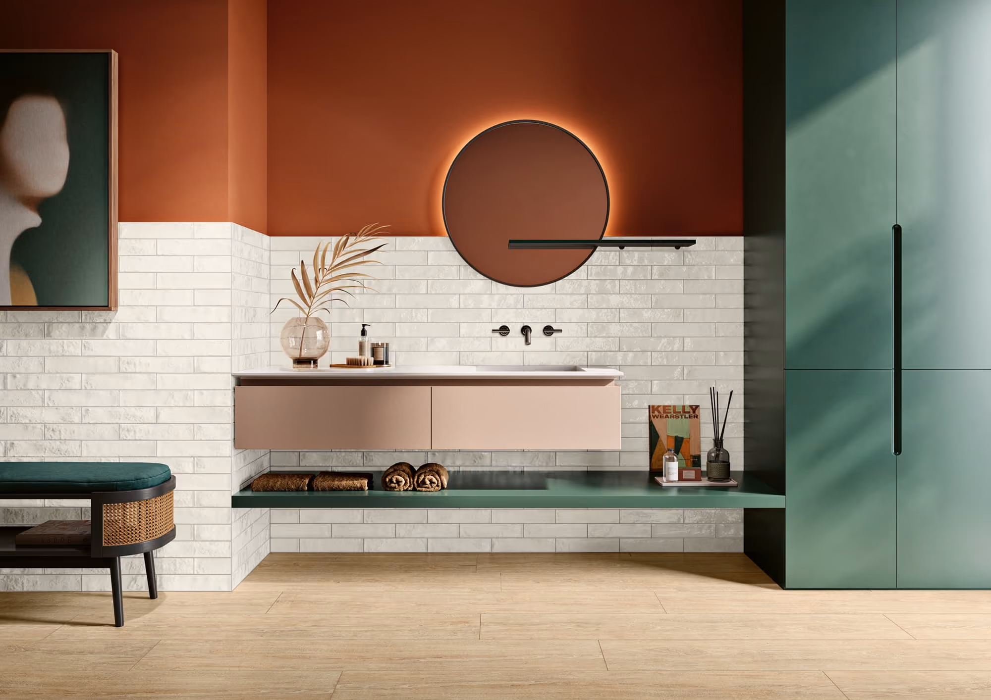 Modern bathroom with round backlit mirror, floating sink cabinet, green bench, and wall art.