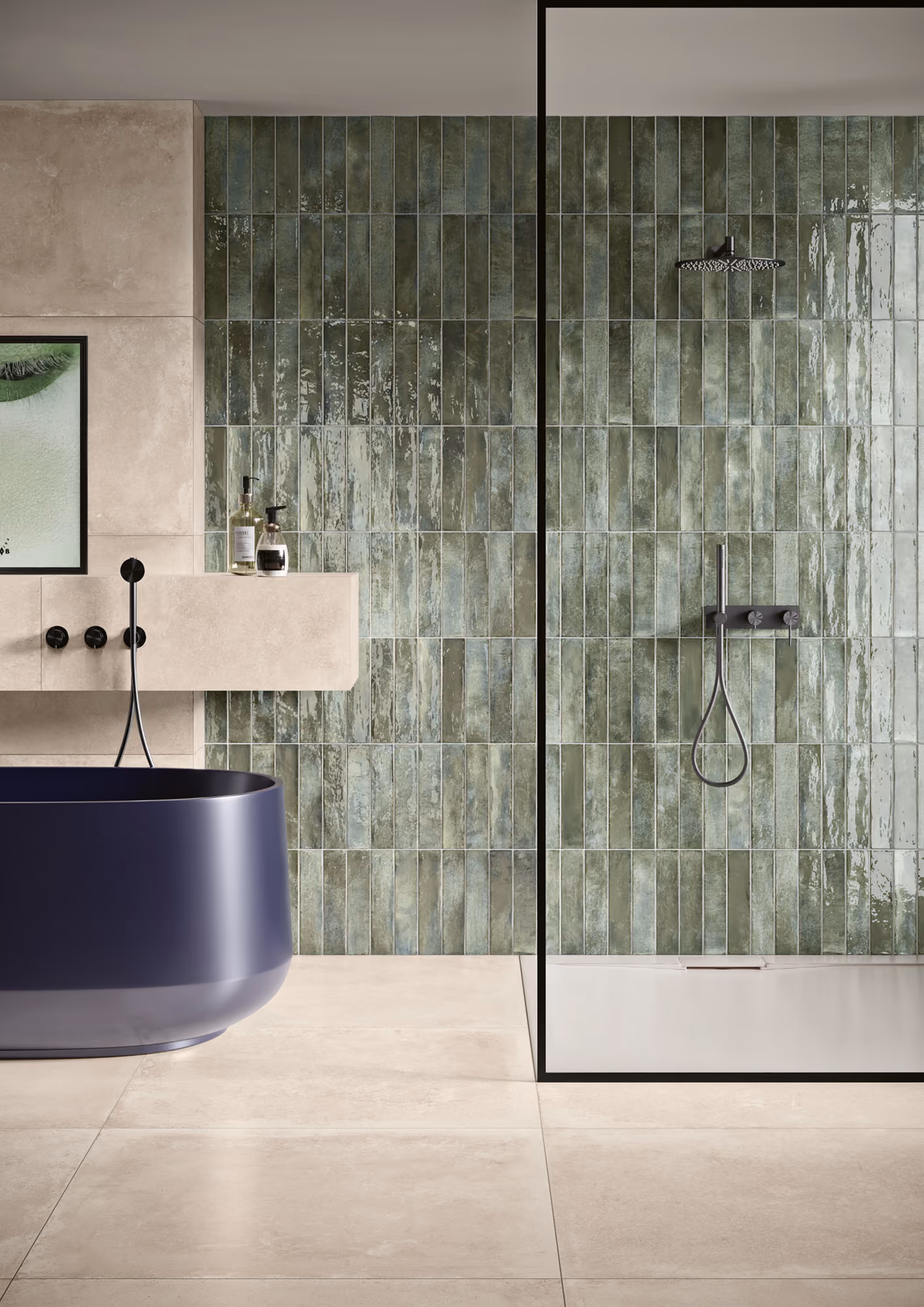 Modern bathroom with navy bathtub, beige tiles, green tiled wall, and glass shower enclosure with black trim.