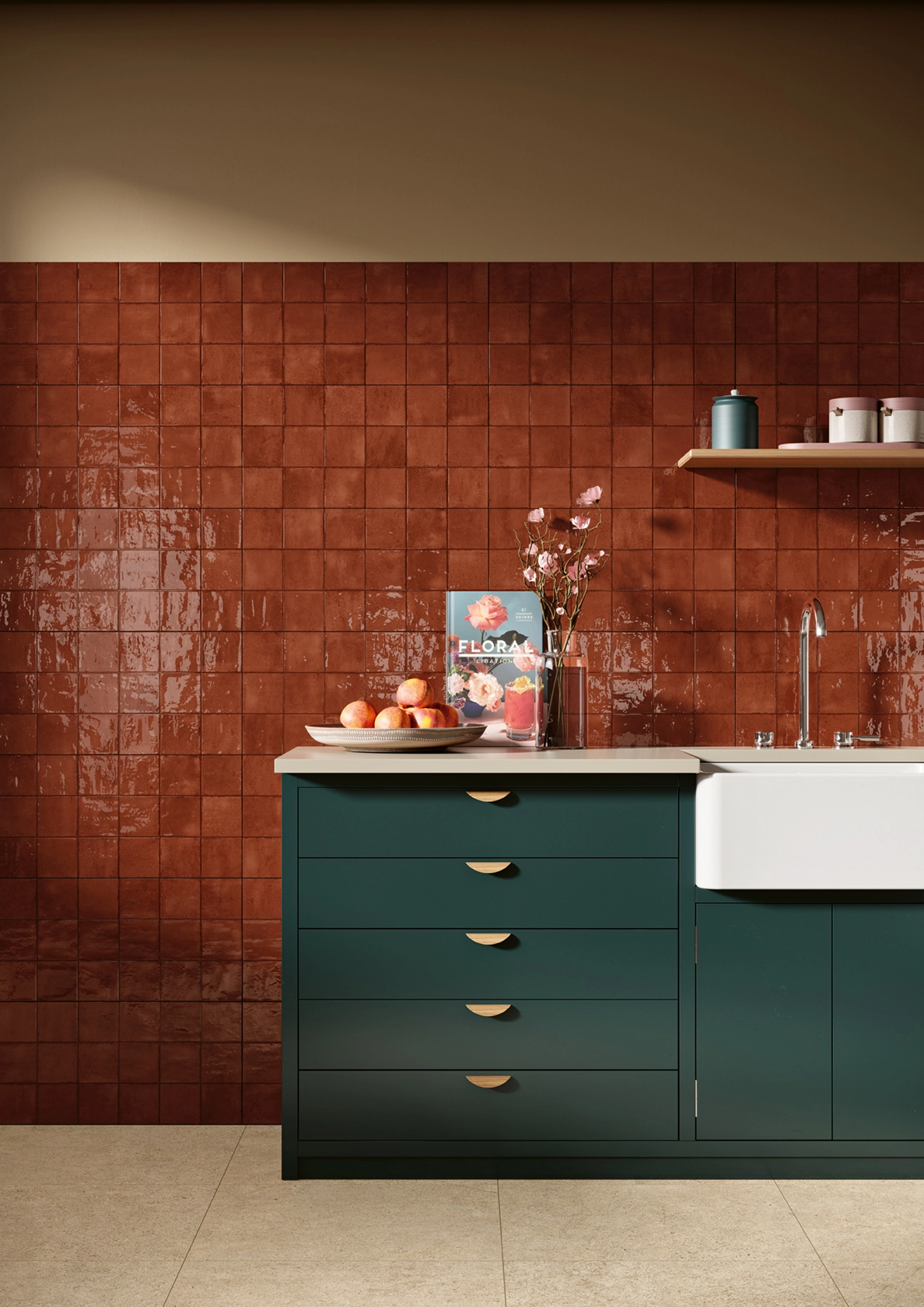 Modern kitchen with green cabinets, white farmhouse sink, red tiled backsplash, plate of peaches, and flowers.