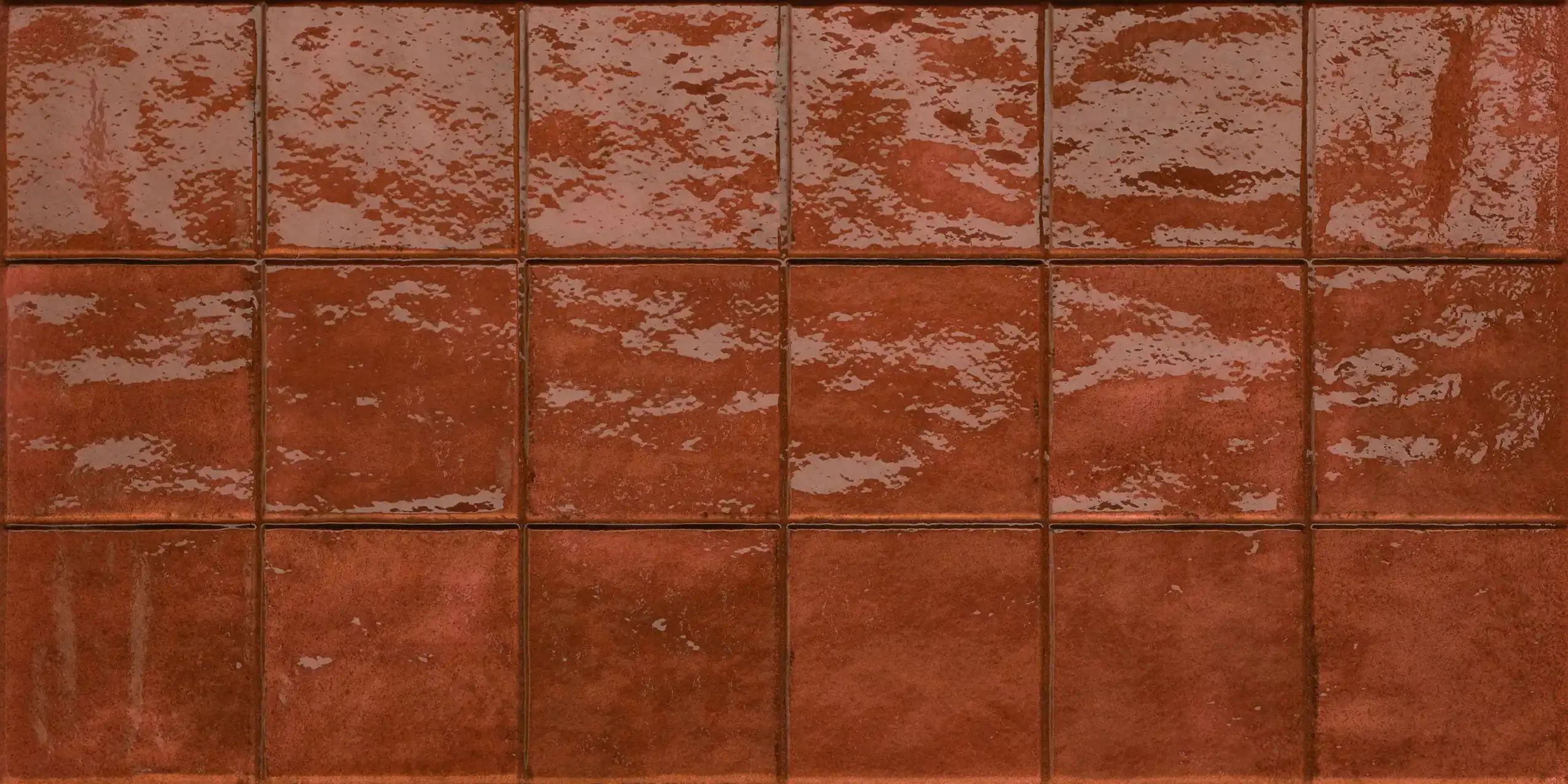 Glazed brown ceramic tiles arranged in a 3 by 7 grid with glossy reflections on the surface.