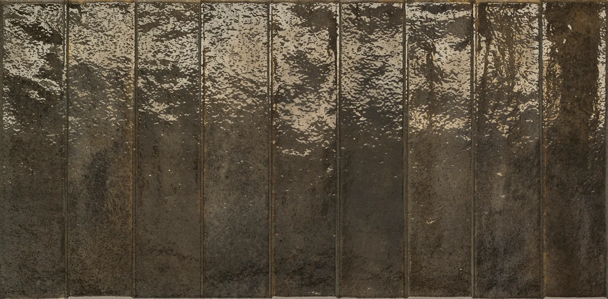 Glossy black rectangular tiles arranged side by side with textured reflective surfaces.