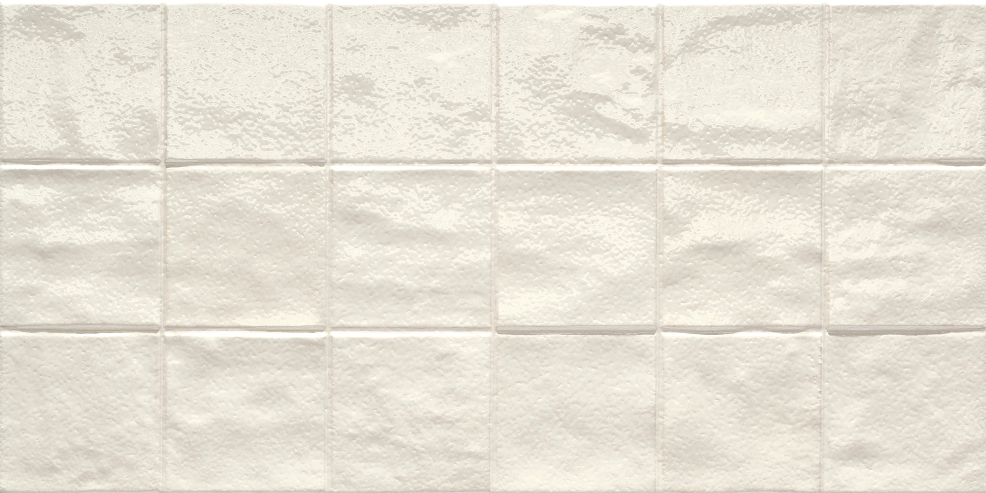 Close-up of glossy white rectangular ceramic tiles arranged in a grid pattern on a wall.