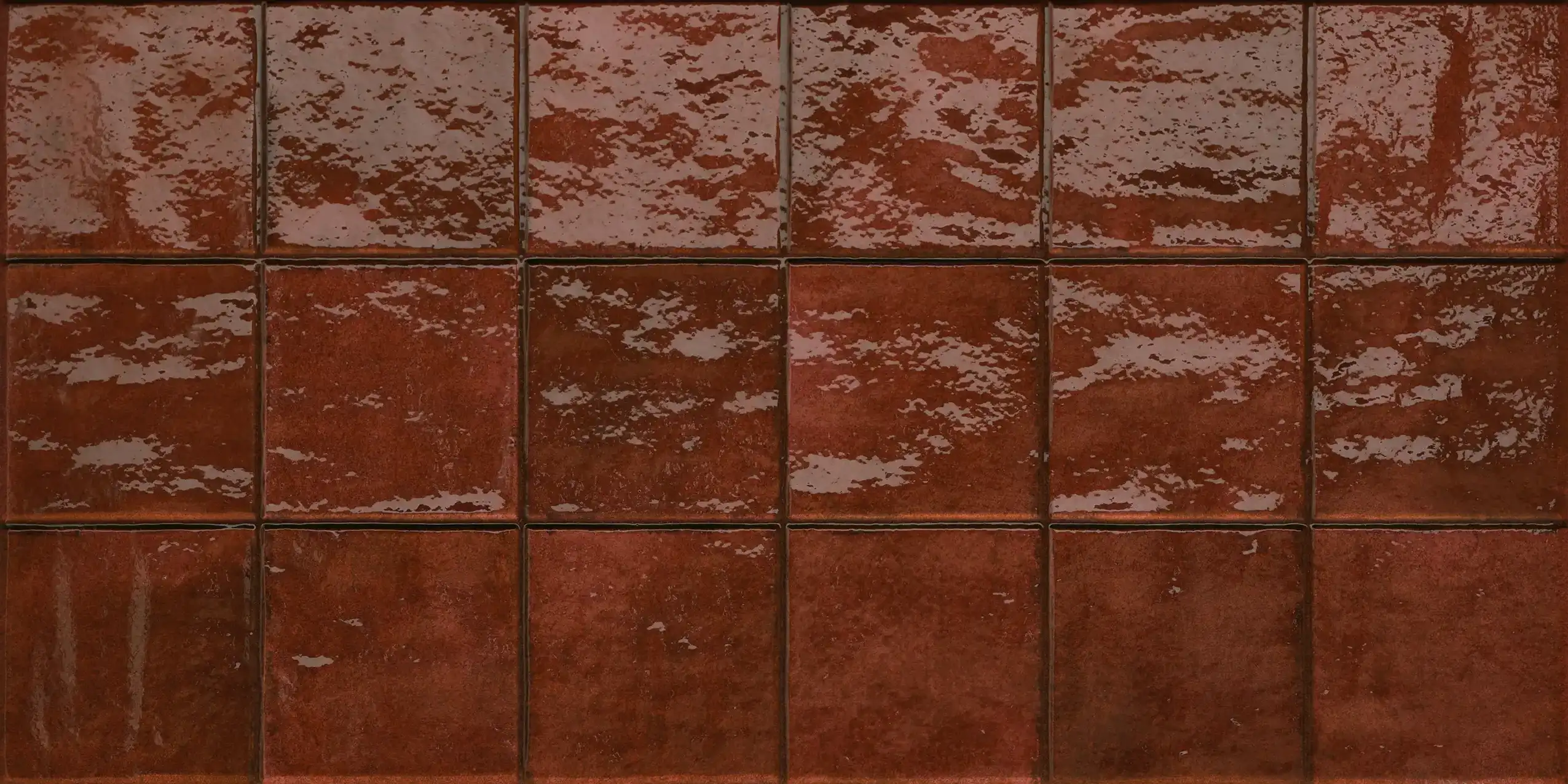 Glazed brown square ceramic tiles arranged in a grid pattern.