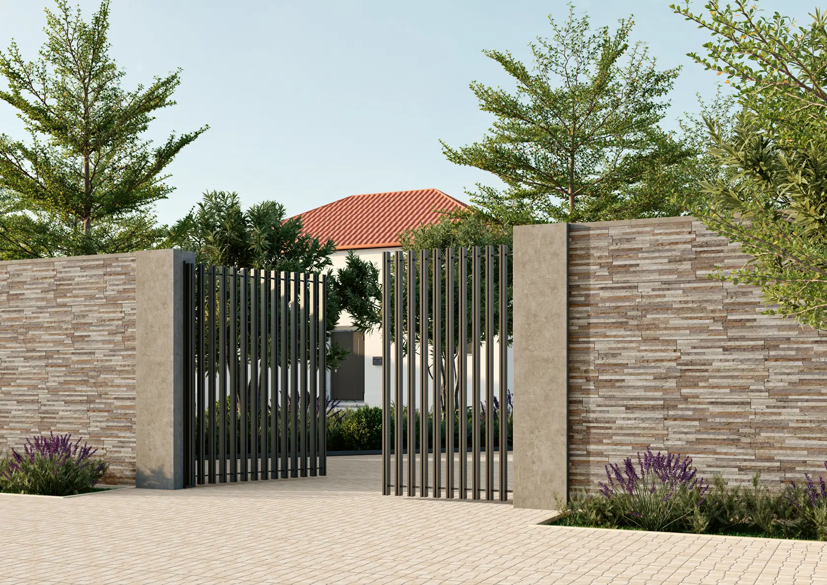 Modern black metal gate open in stone wall leading to house with red tile roof and landscaping.