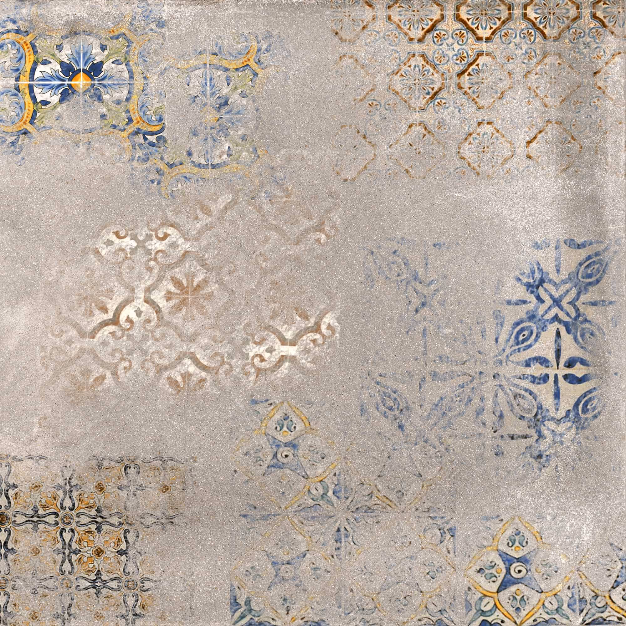 Worn vintage tile pattern with faded blue, yellow, and brown ornamental designs on gray surface.
