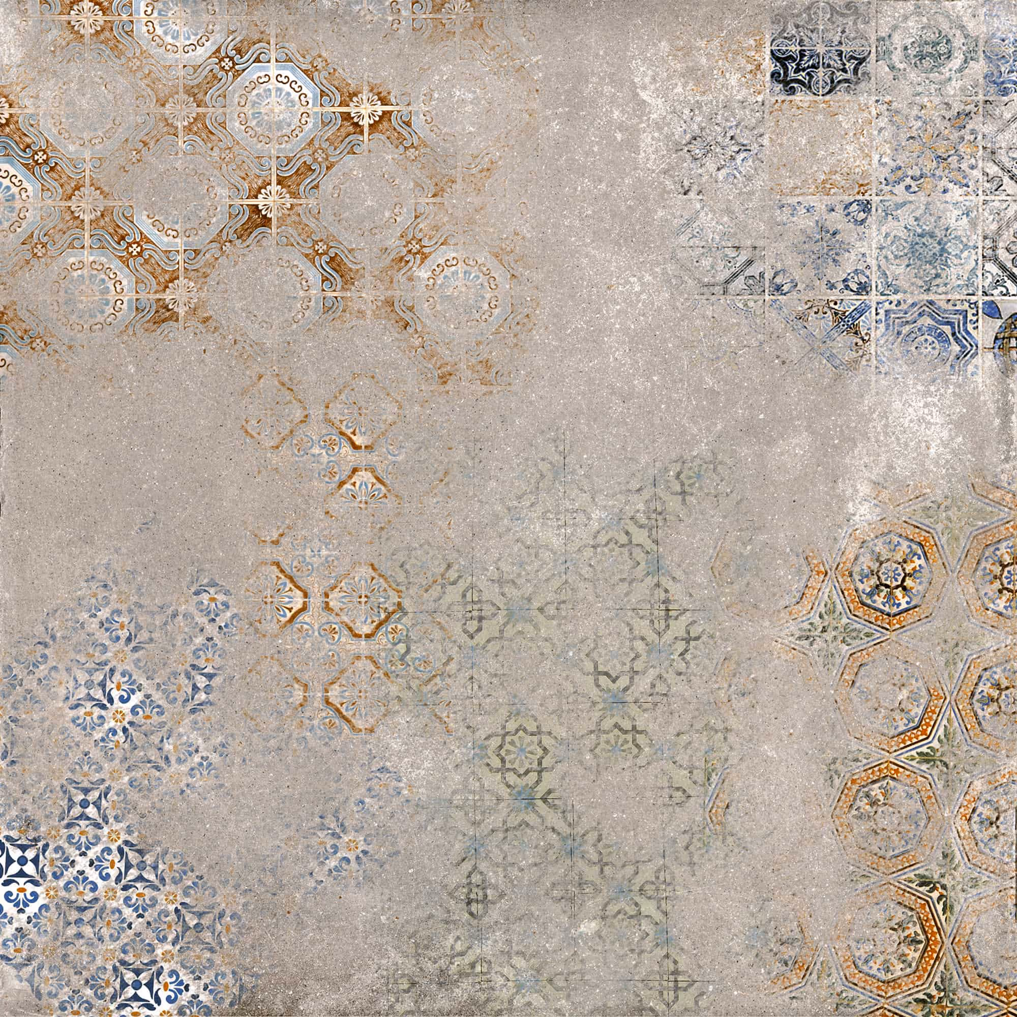 Worn decorative tiles with faded geometric patterns in blue, brown, and beige on gray surface.