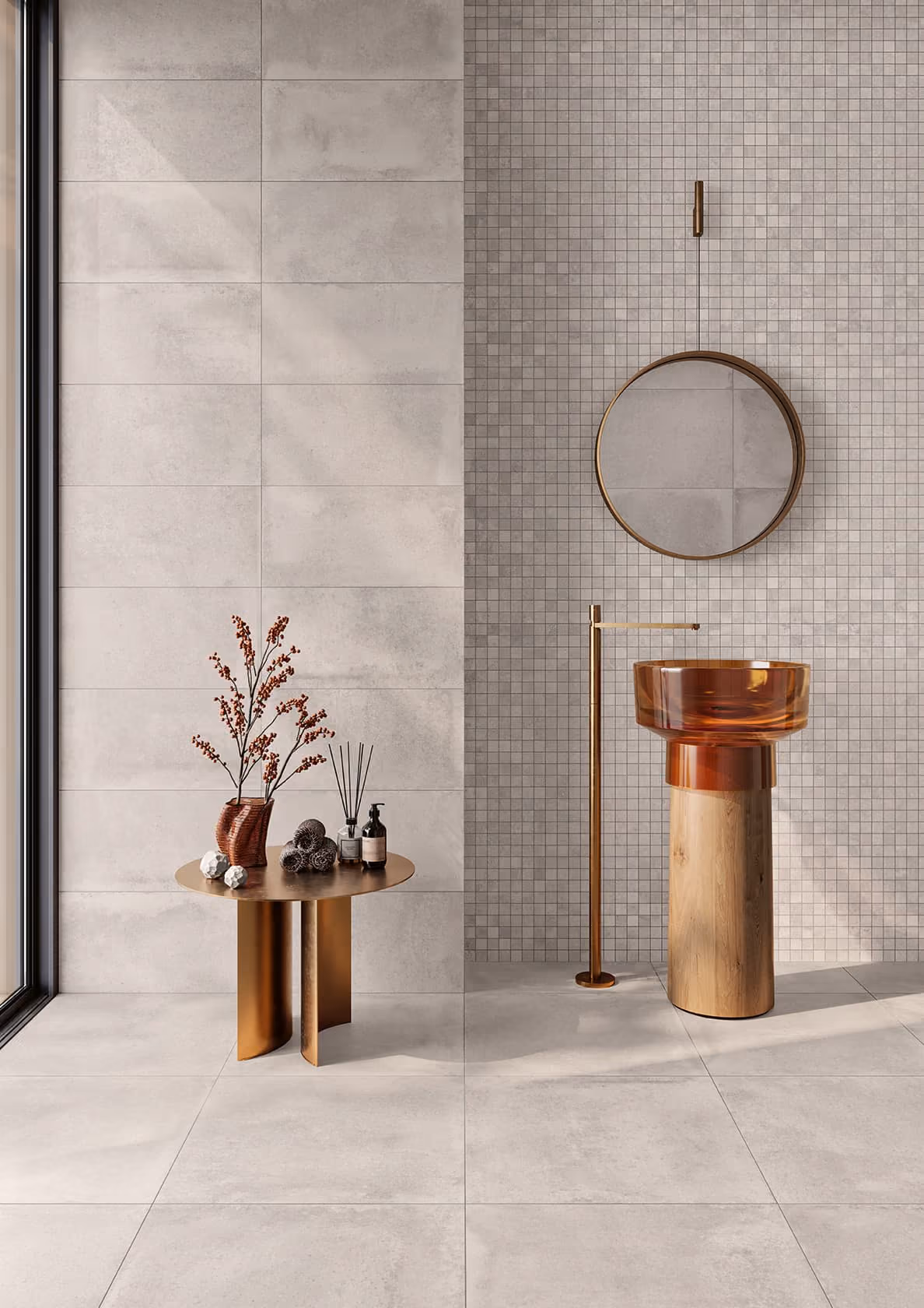 Minimalist bathroom with a round amber sink on a wooden pedestal, gold faucet, round mirror, and gold table with decor.