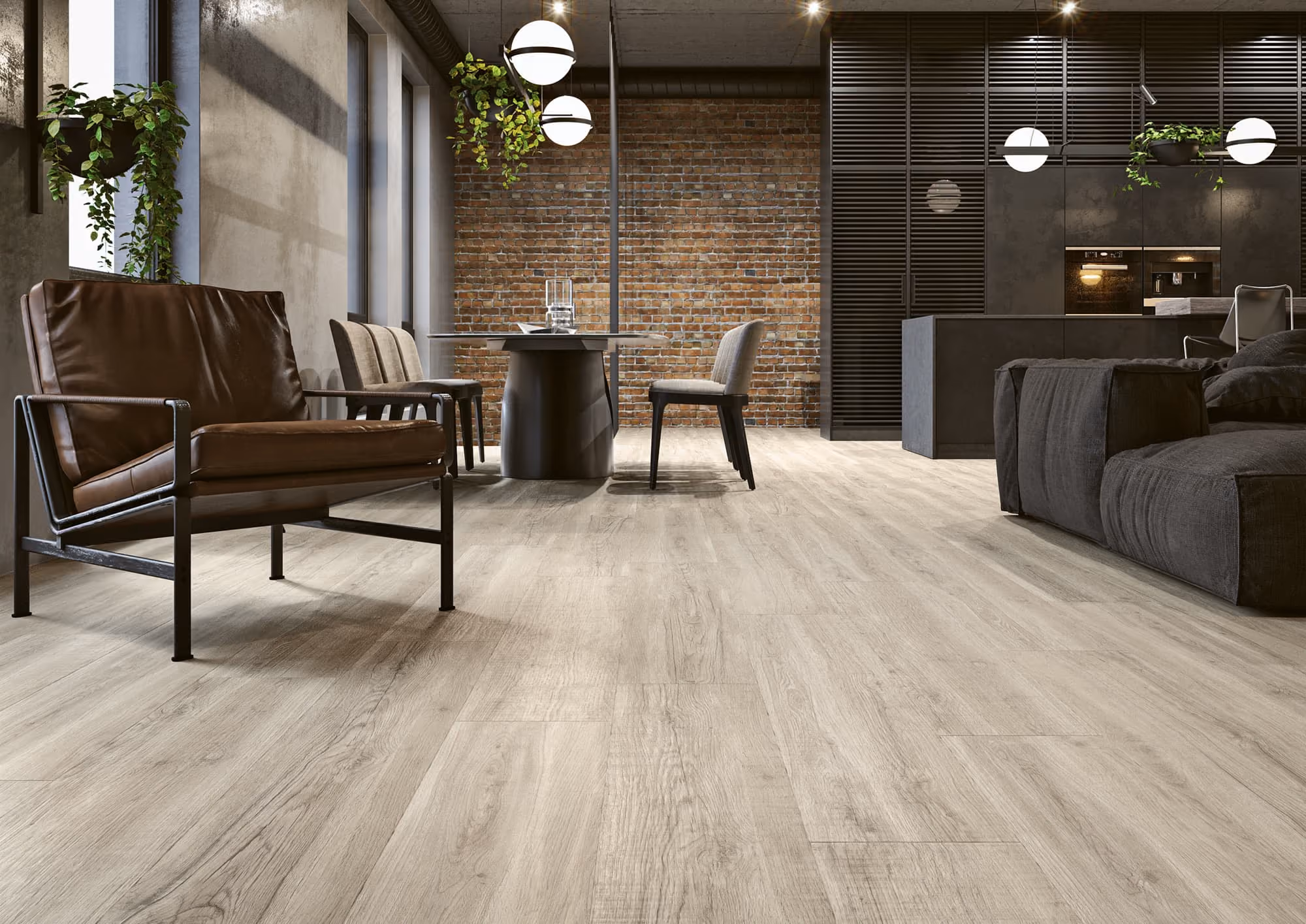 Modern living room with light wood flooring, brick wall, leather chair, gray sofa, and hanging plants.
