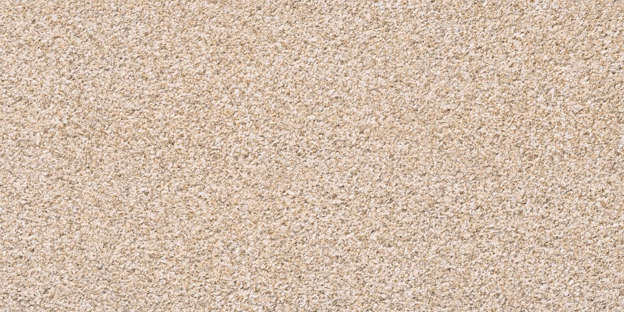Beige textured surface resembling fine gravel or rough stone material.