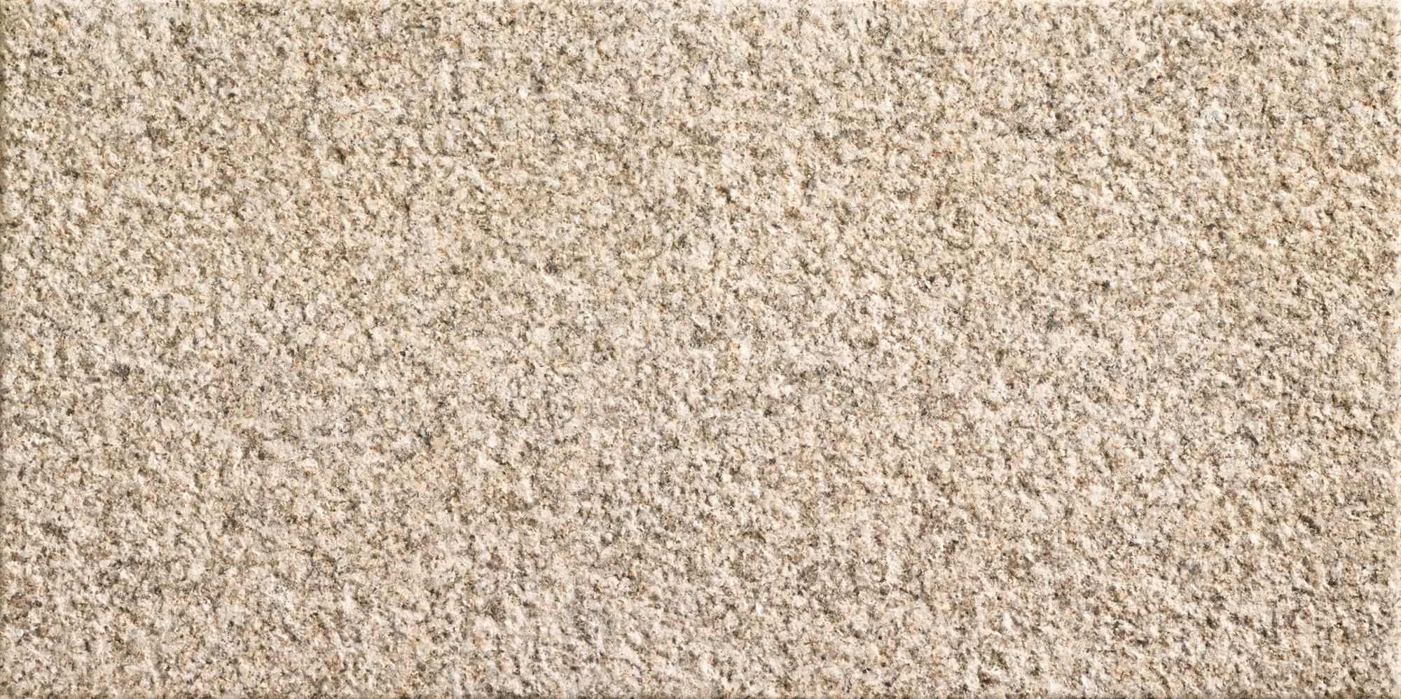 Close-up texture of rough beige and light brown stone surface.