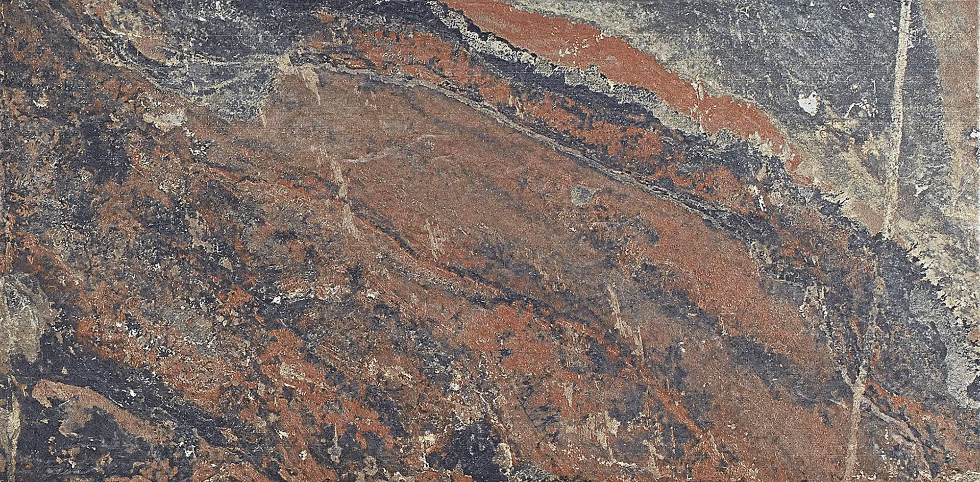 Close-up of multicolor slate stone with textured patterns in gray, rust, and beige tones.