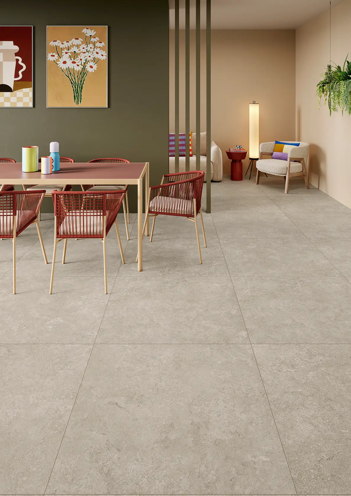 Modern dining and sitting area with beige stone tile floor, red chairs, and wall art.