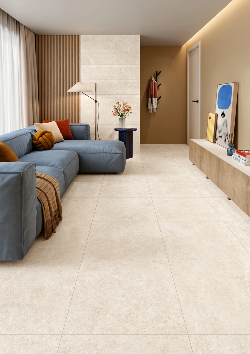 Modern living room with blue sectional sofa, beige tiled floor, wooden accents, and wall art on sideboard.