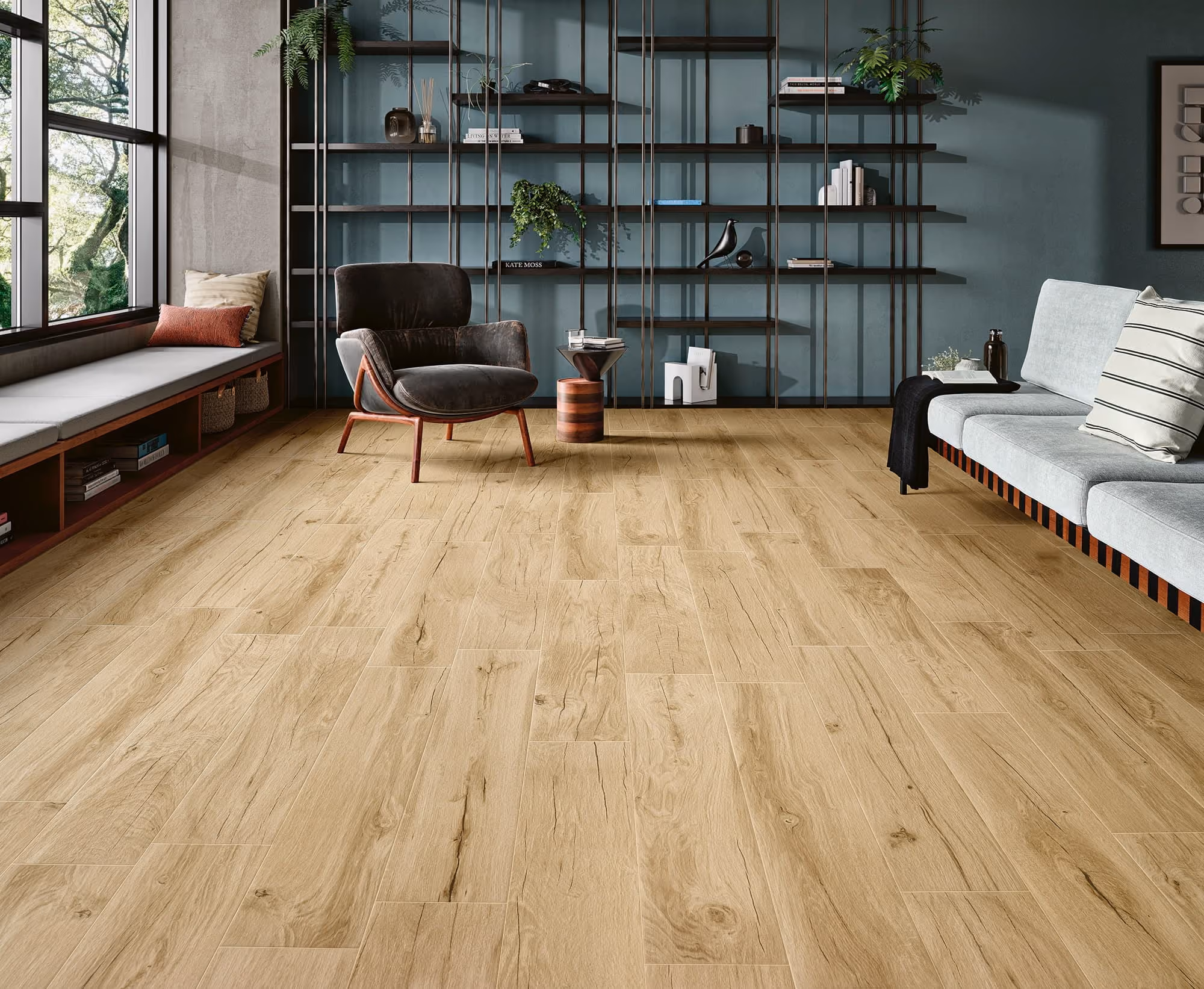 Modern living room with light wood floor, black armchair, light gray sofa, and large window seat.