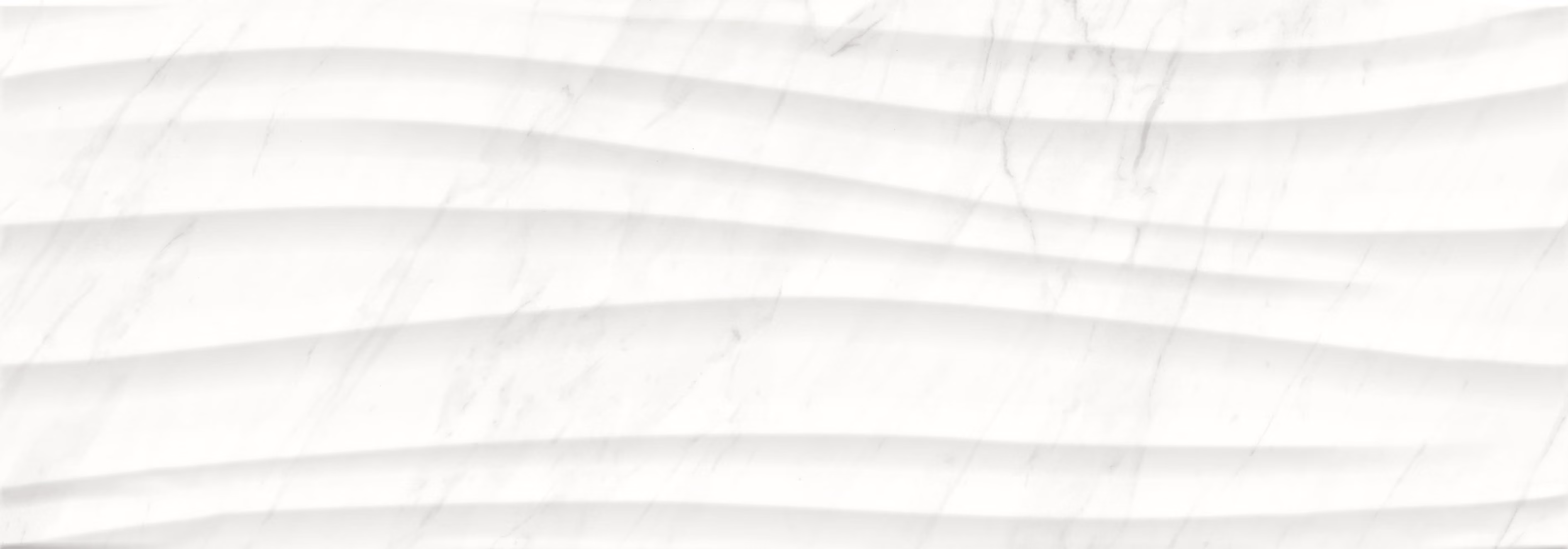 White marble surface with subtle gray veining and horizontal wave-like ridges.