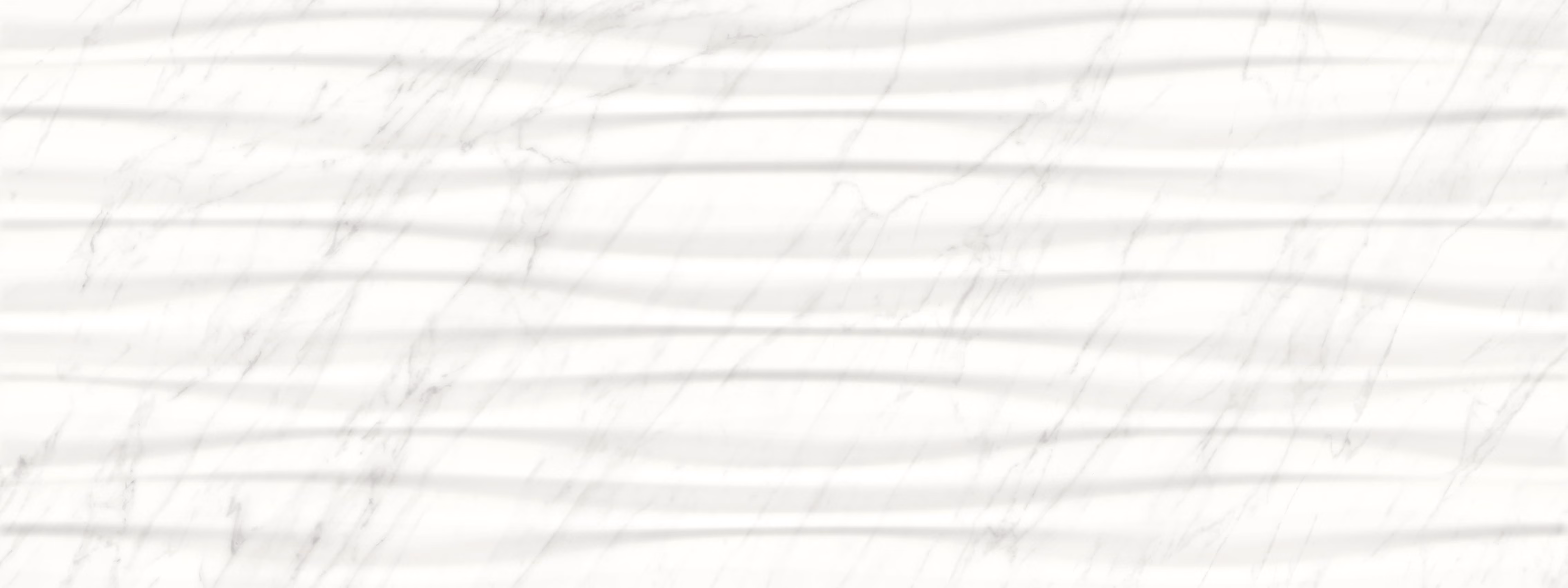 White marble surface with subtle gray veins and shadow stripes across it.