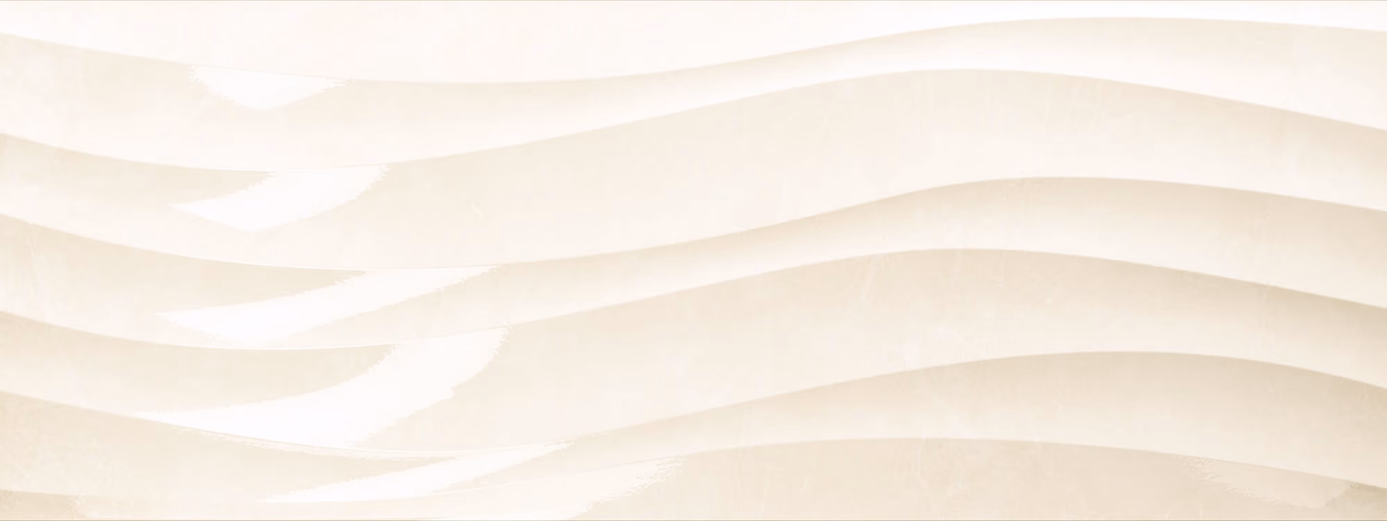 Cream-colored marble with wavy, flowing patterns in lighter and darker shades.