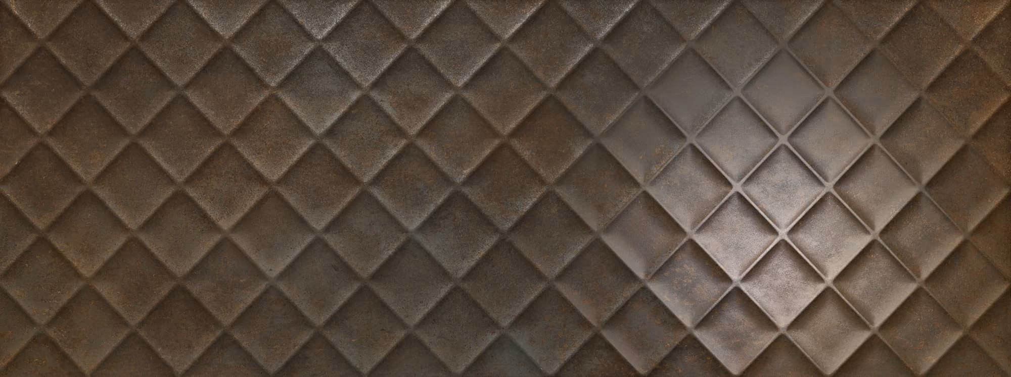 Close-up of a metallic surface with a diamond quilted pattern in bronze and gray tones.