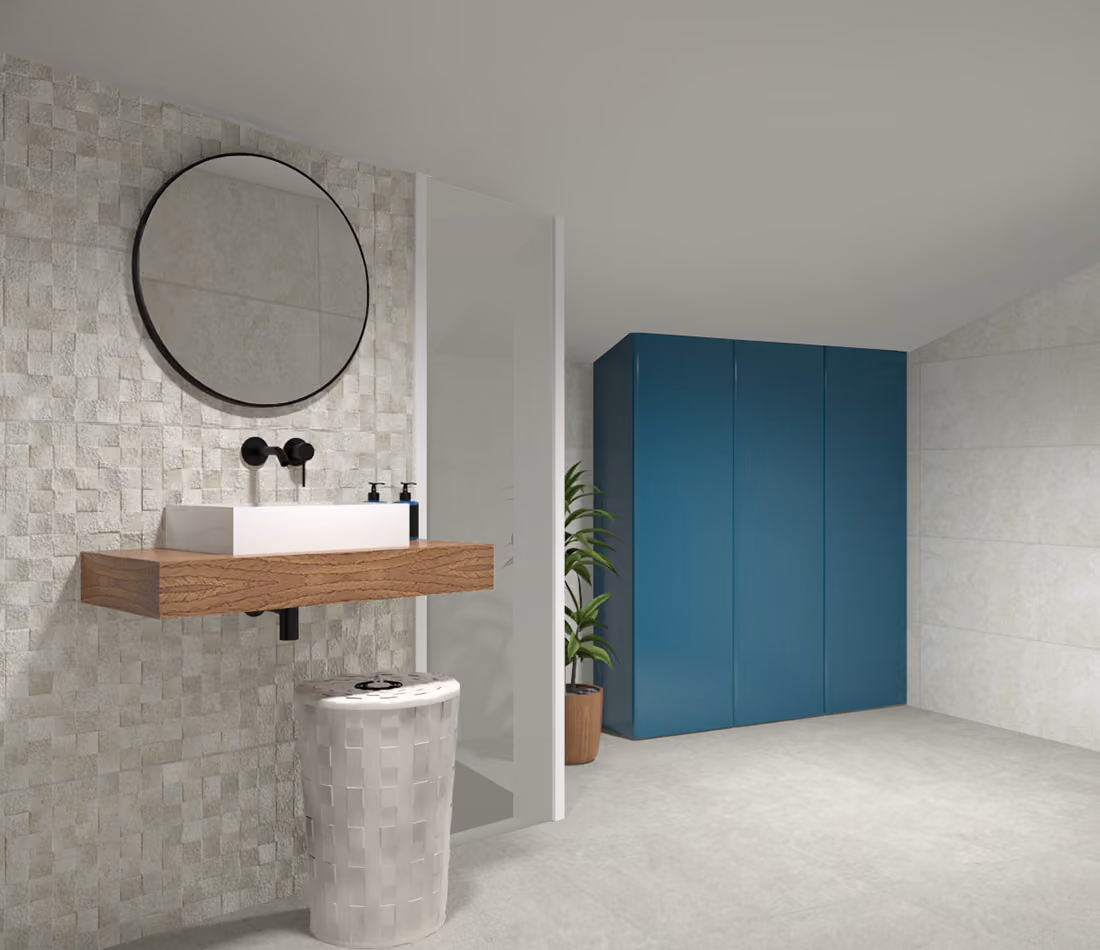 Modern bathroom with textured wall, floating wooden sink, round mirror, plant, and blue cabinet.