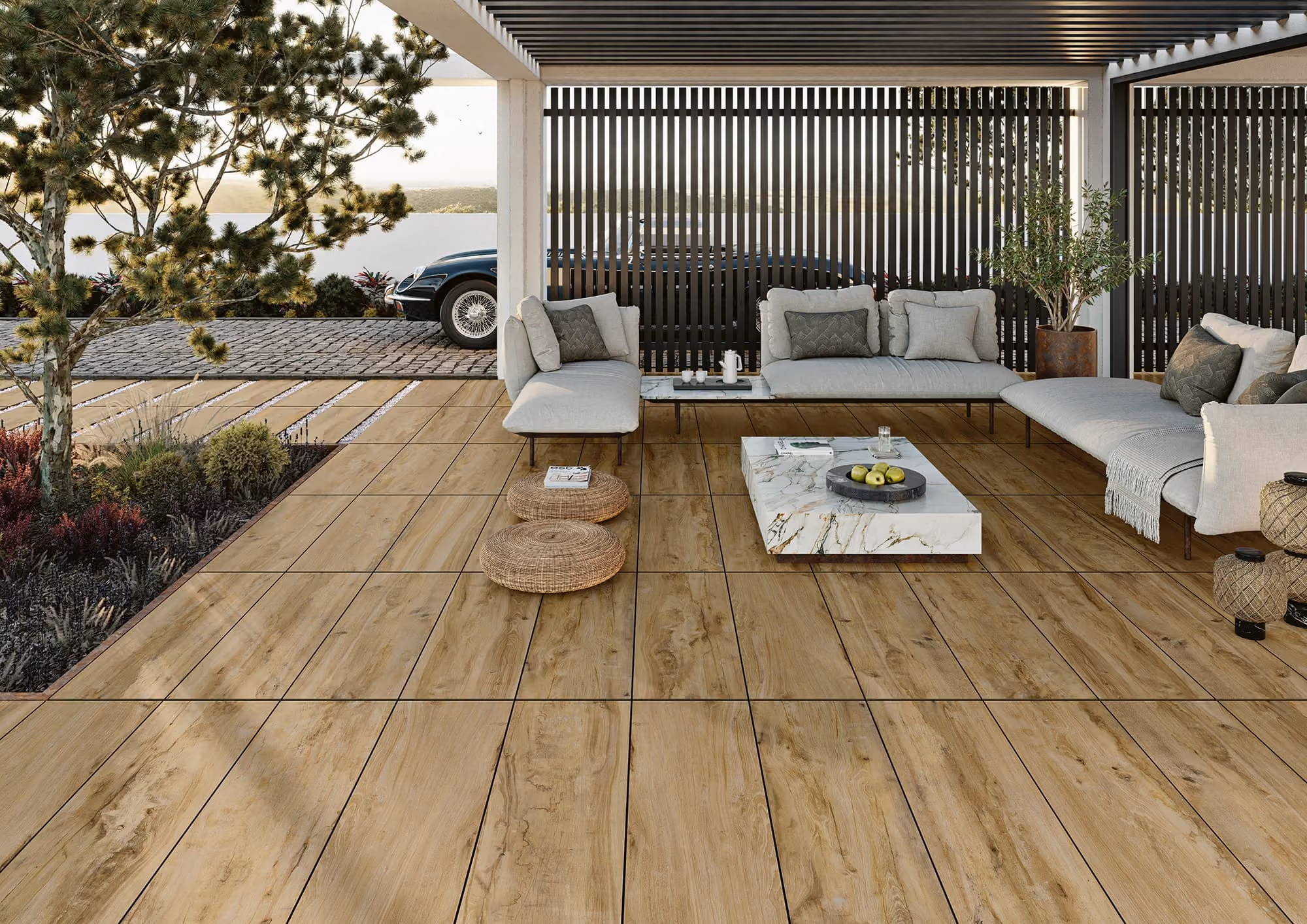 Modern outdoor patio with wood-look tile flooring, cushioned seating, and a marble coffee table.
