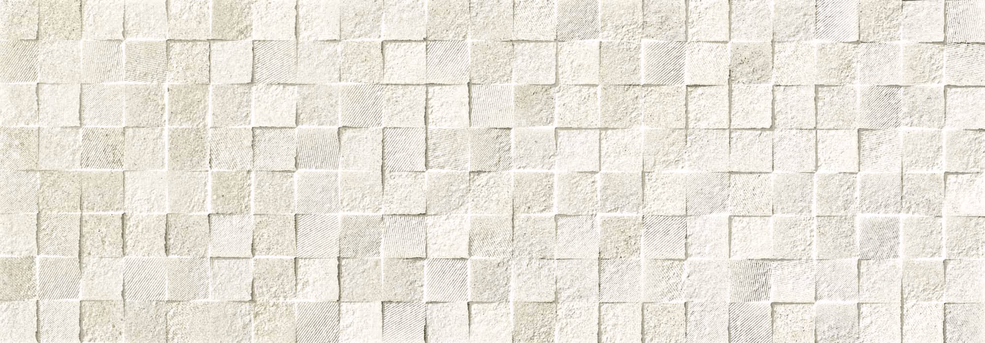 Wall of small square stone tiles arranged in a textured mosaic pattern in pale beige tones.