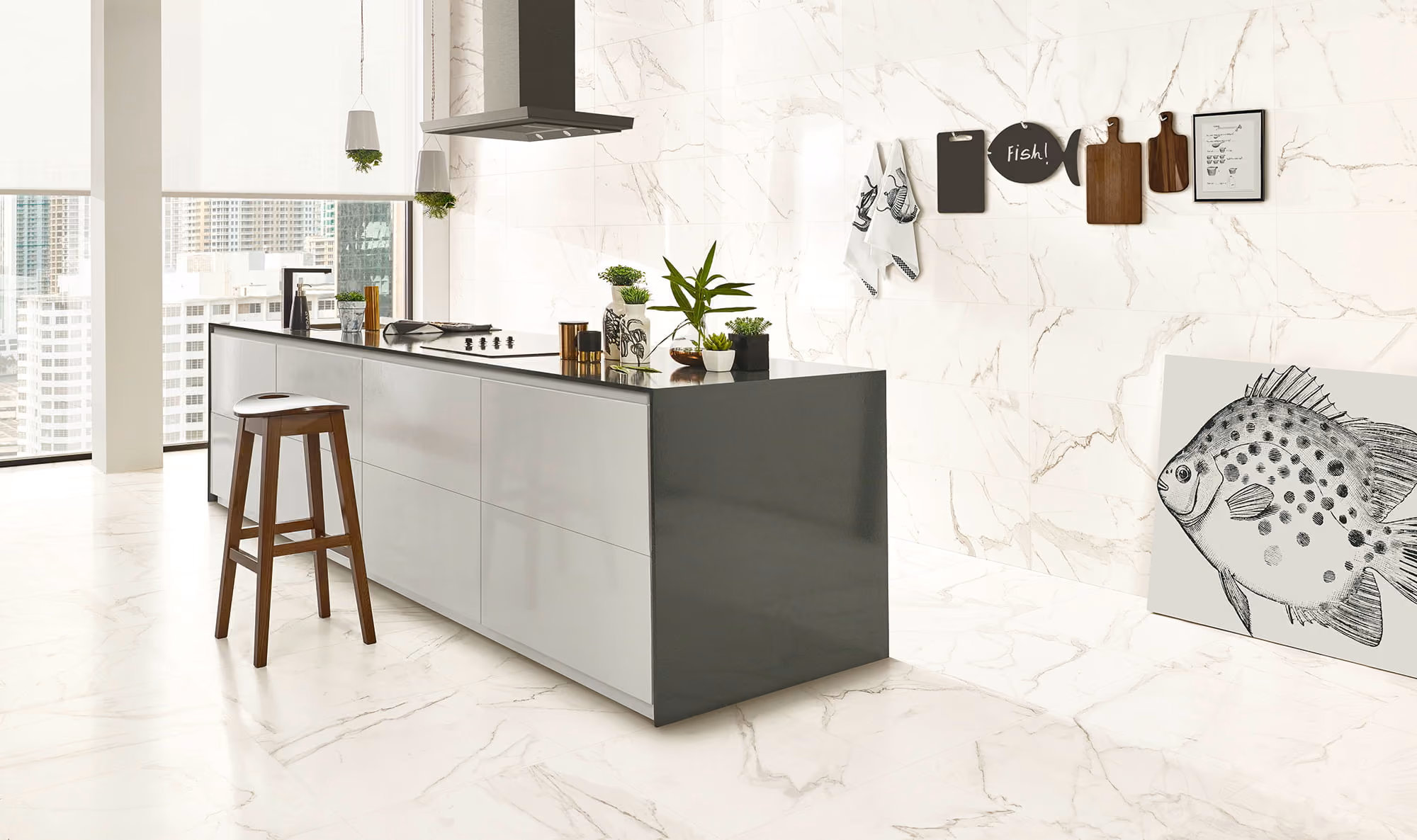 Modern kitchen with marble floors, a gray island, wooden stool, hanging plants, and fish-themed wall decor.