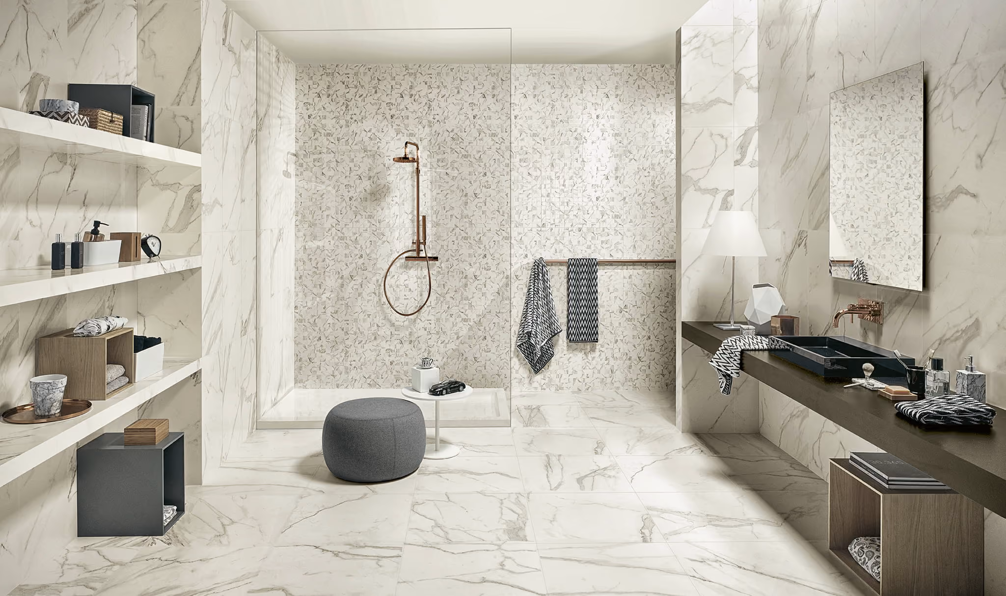 Modern bathroom with marble walls and floor, walk-in shower, black sink, shelves, and gray stool.
