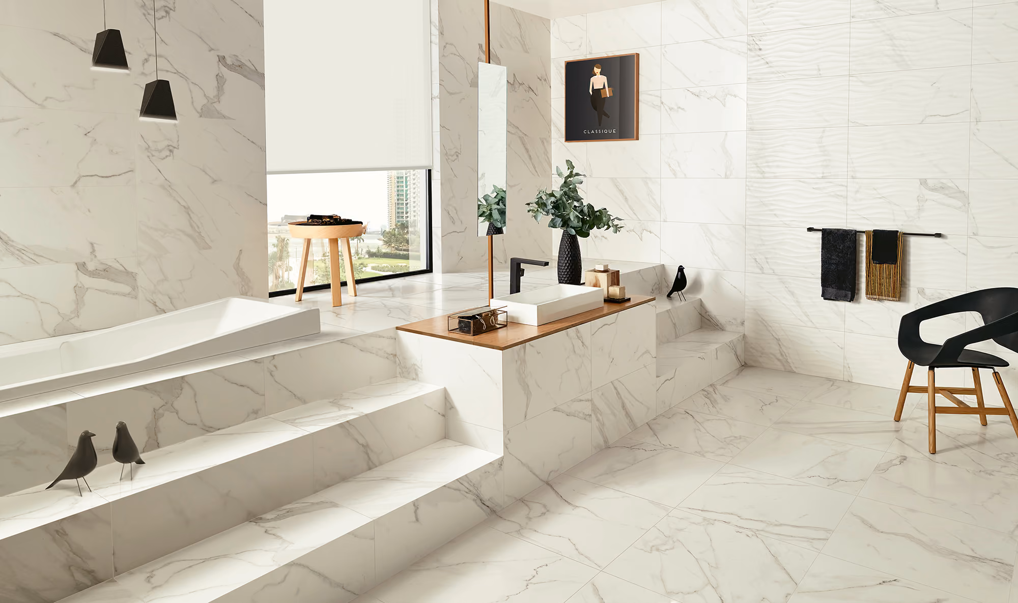 Modern bathroom with white marble tiles, a built-in bathtub, steps, black chair, and decorative plants.