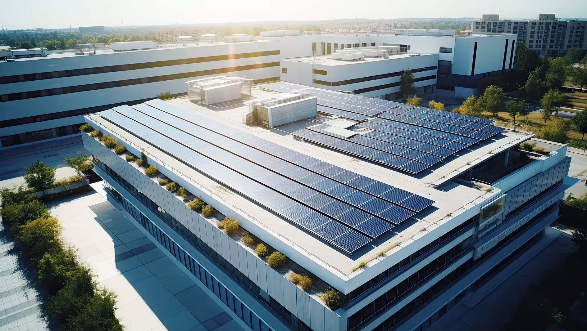 Modern building rooftop covered with solar panels under bright sunlight.