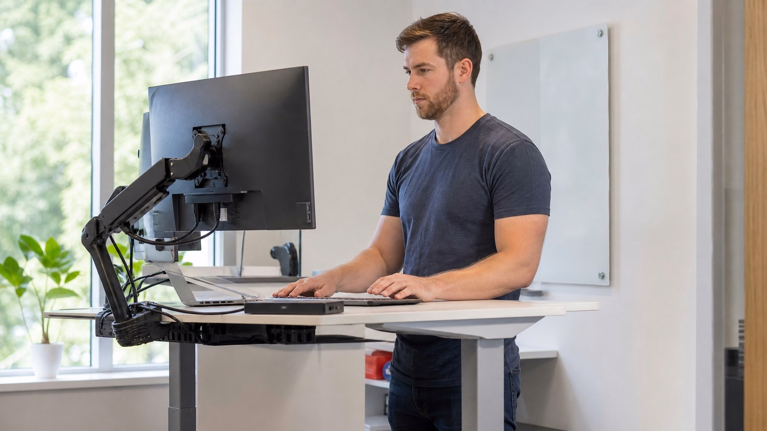 STANDING DESK An IT professional  one person standing at a height-adjustable