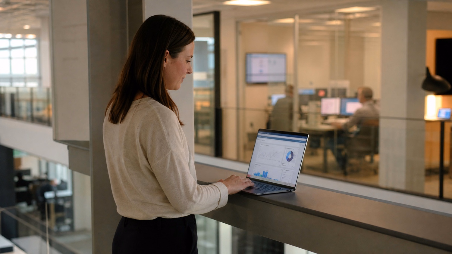 Woman on balcony reviewing SharePoint stats on laptop 62 chars