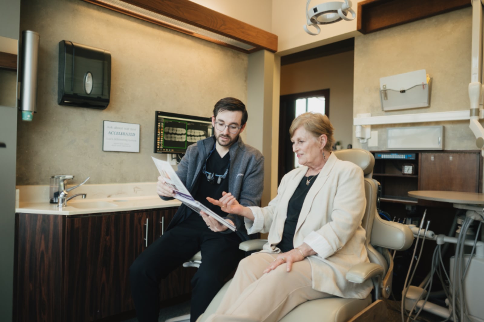 Dentist discussing treatment plan with patient in consultation room
