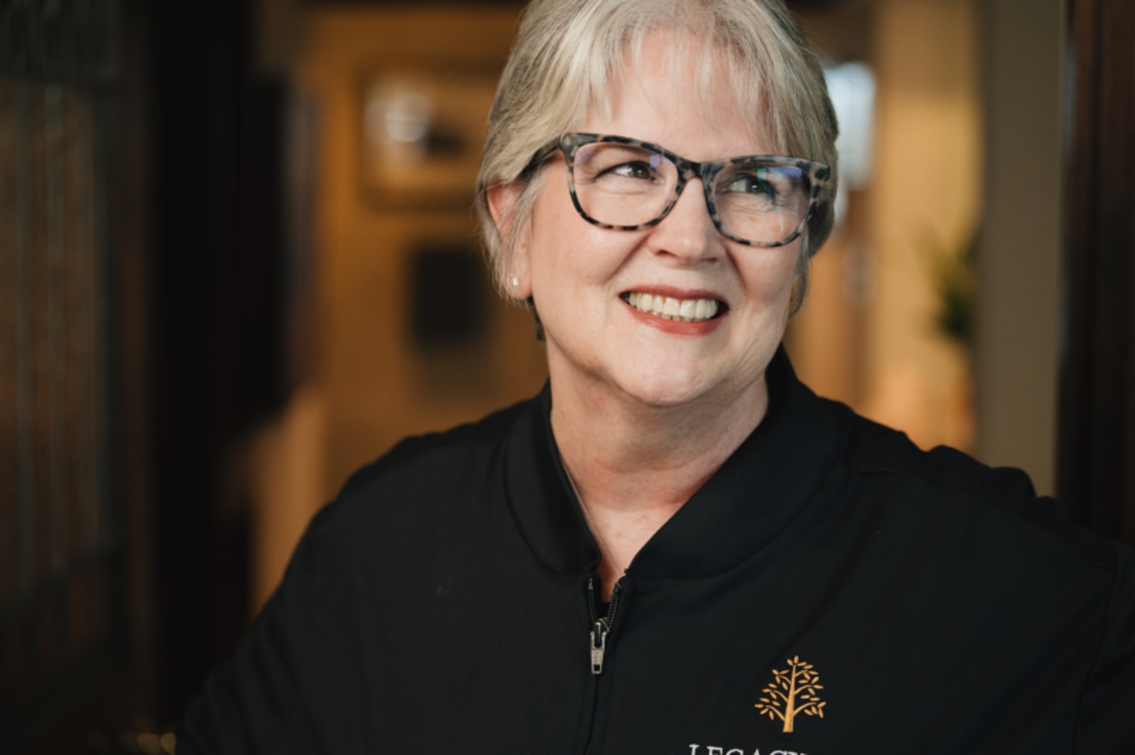 Portrait of smiling female dentist in black Legacy Oak branded jacket