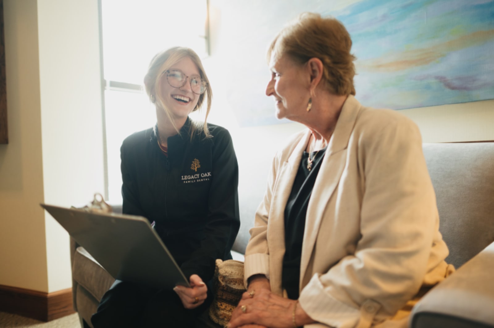 Dental professional consulting with patient in treatment room
