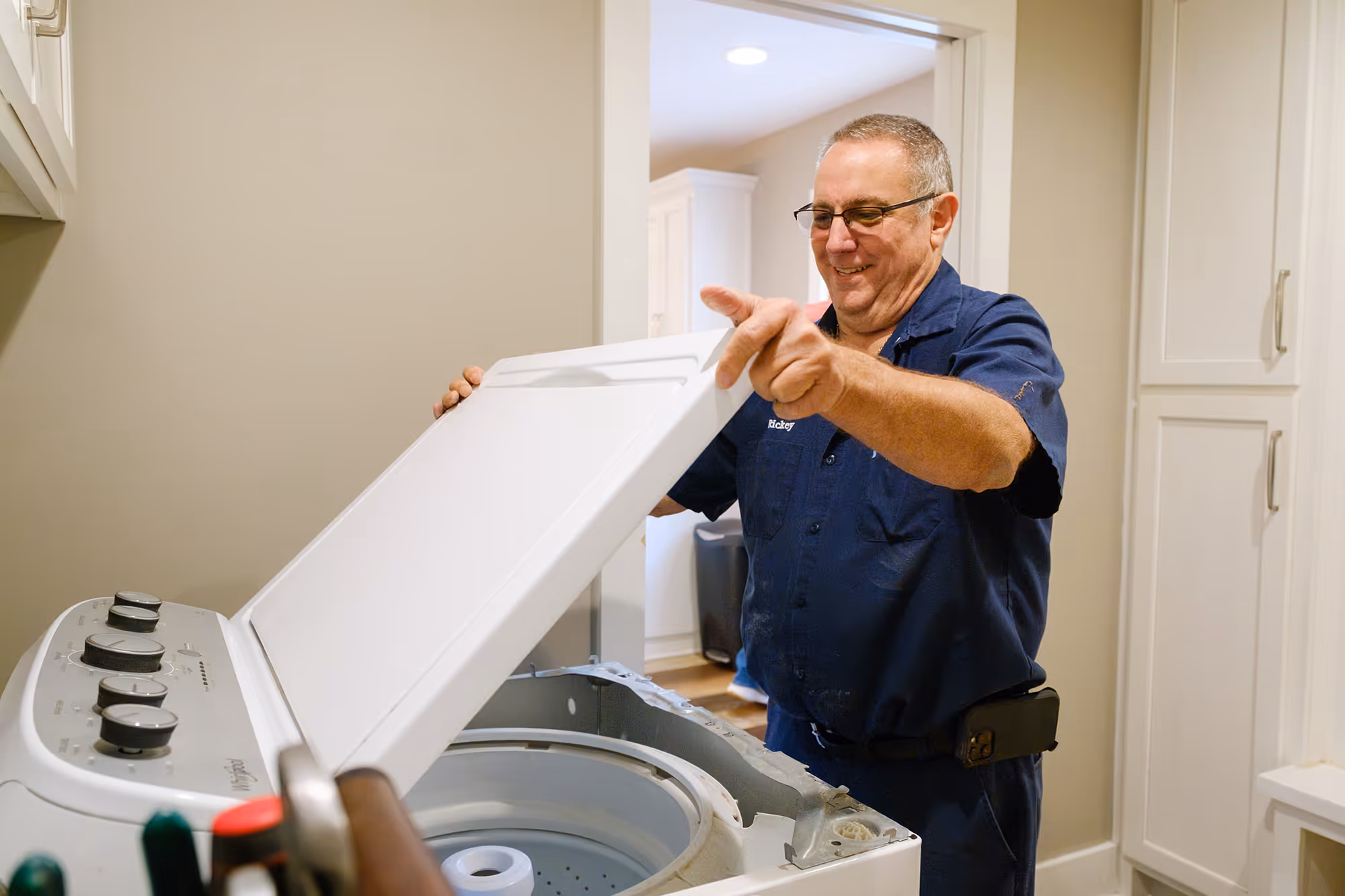 Technician repairing a washing machine for D&D Appliance Repair in Bowling Green, KY