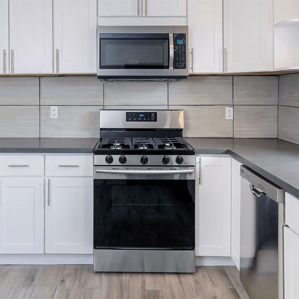 Stainless steel gas range and oven in a kitchen, representing D&D's oven, range, and stove repair service