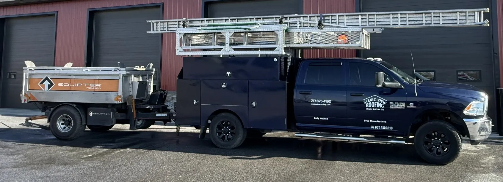 Navy blue Scenic View Roofing truck with Equipter roofing buggy behind it.