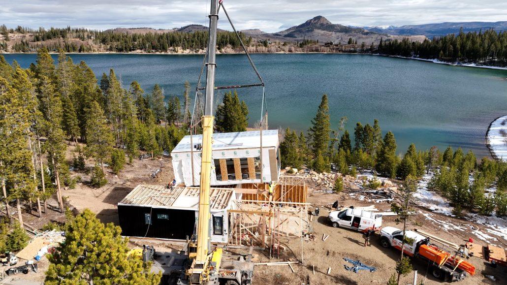 Installing modular home by mountain lake