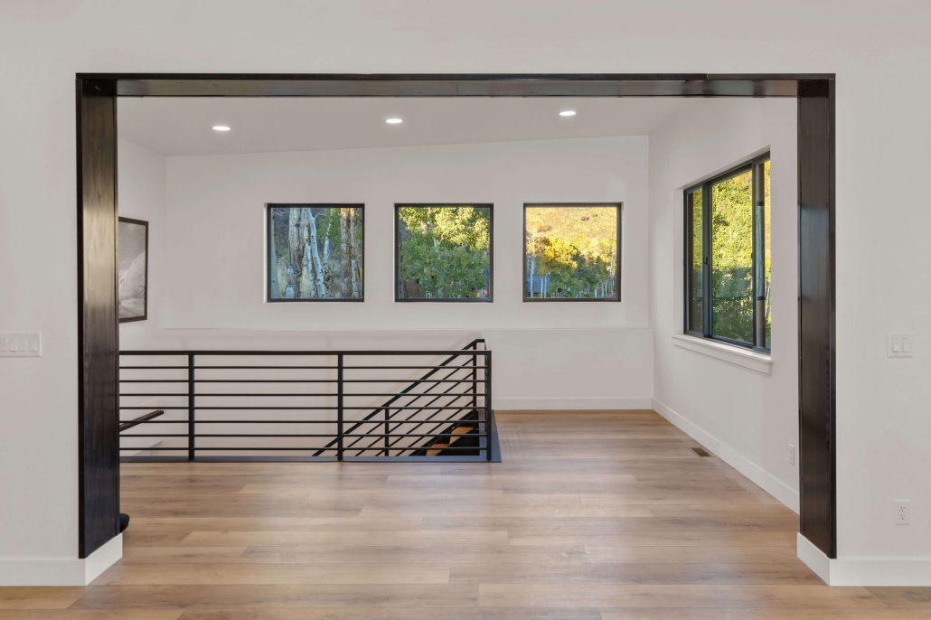 windows by stairway to bring in nature for wellness in custom prefab home in Colorado by SmartPads