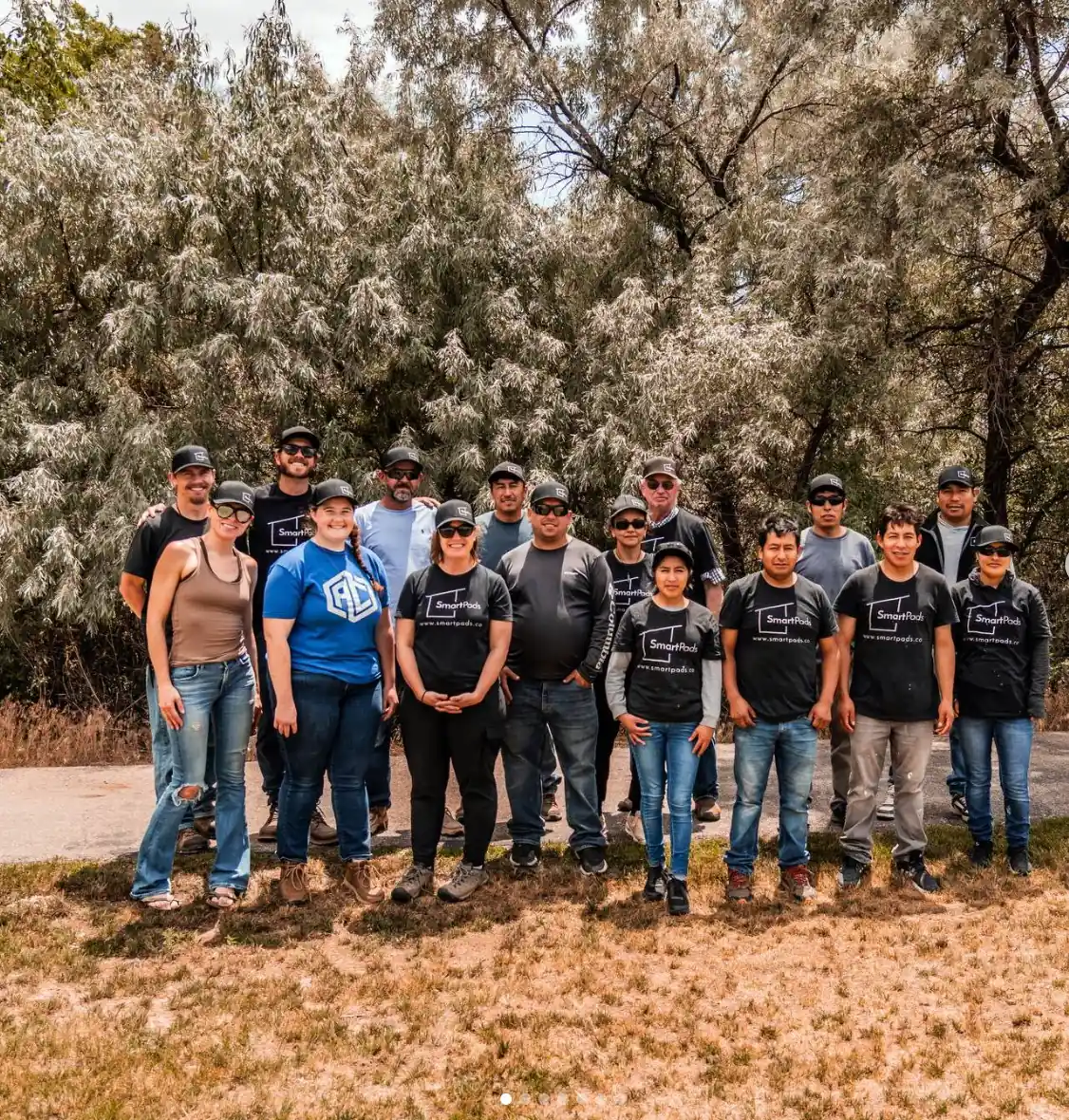 Full Smartpads team group photo outdoors with trees in the background